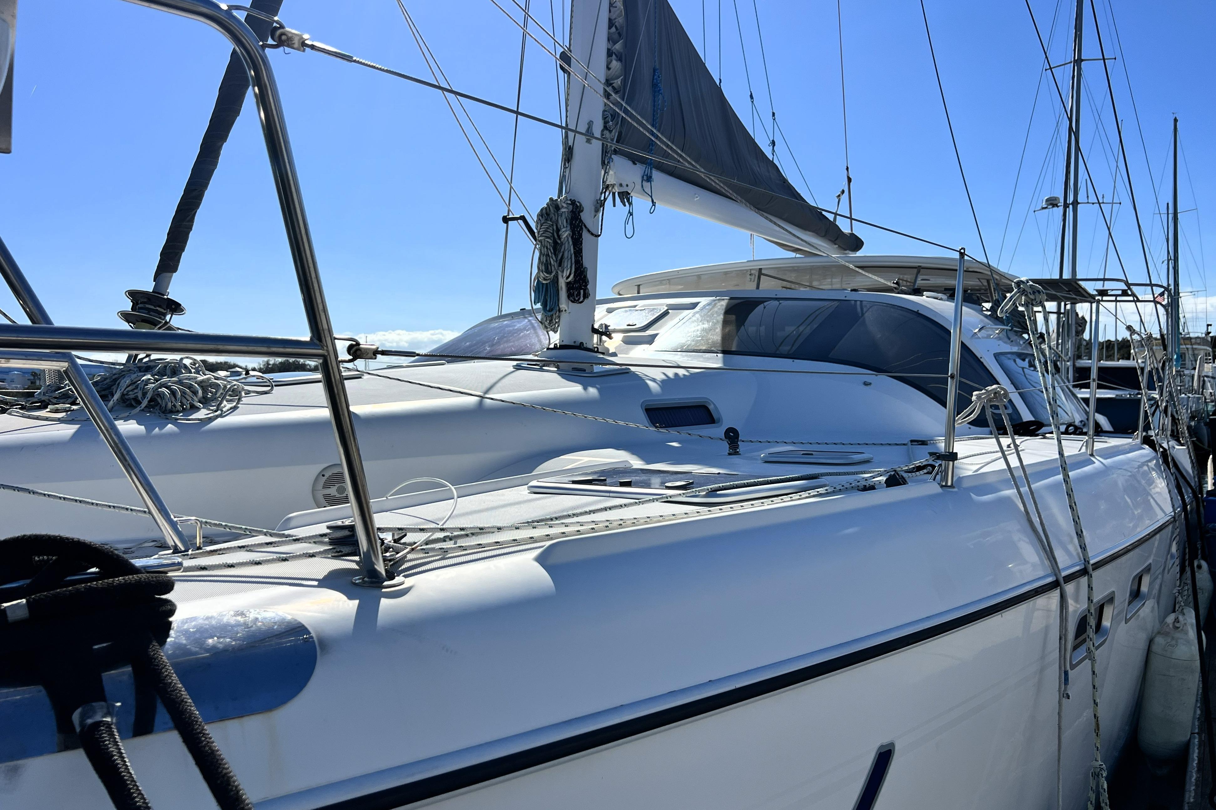 Sleek 2011 Privilege 495 yacht docked under clear blue sky.