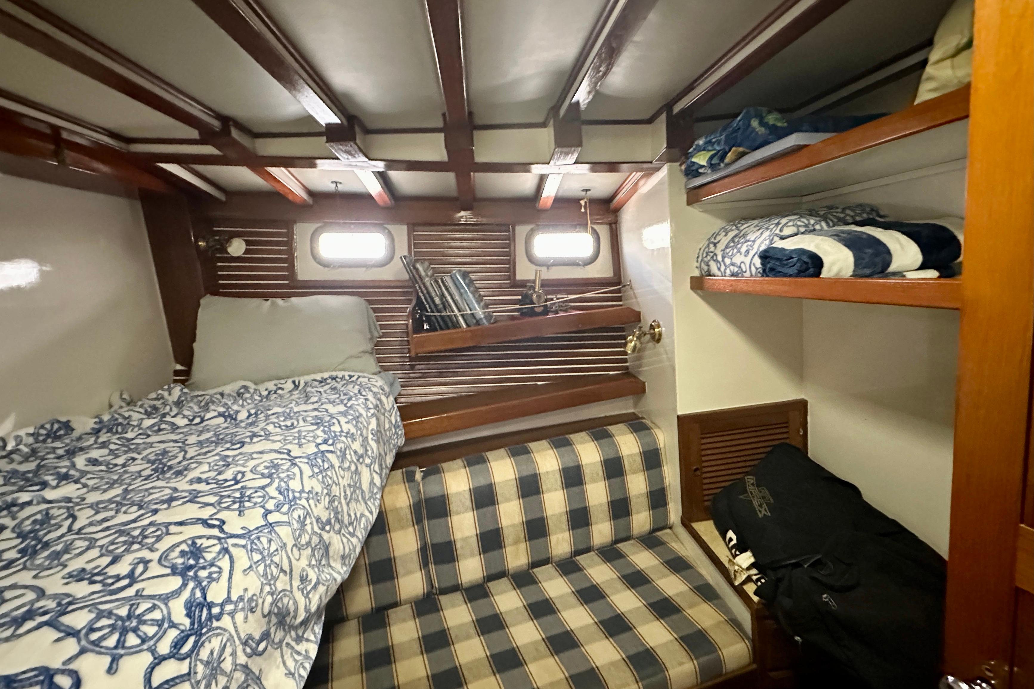 Cozy cabin interior of 1983 Kadey-Krogen Krogen 42 Trawler with bunk beds and storage.