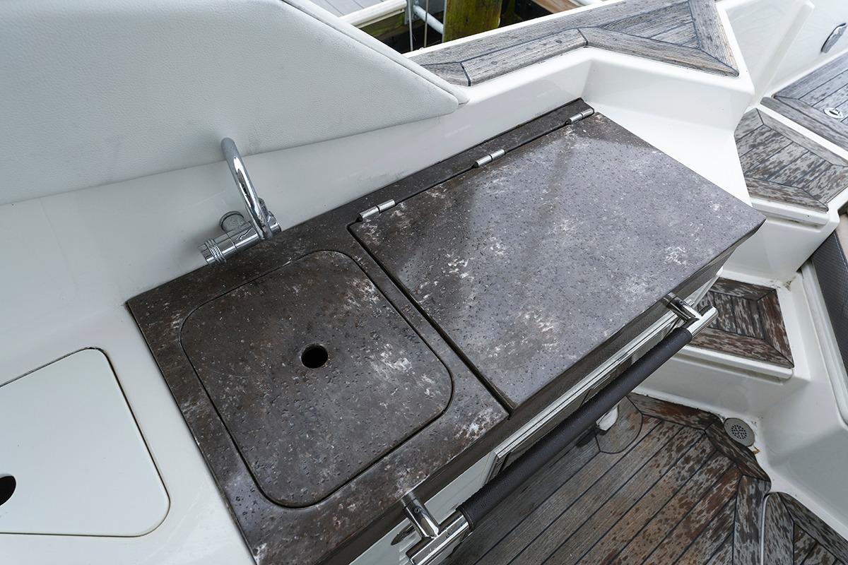 Outdoor kitchen area on a 2018 Sea Ray SLX 350 boat with sink and countertop.