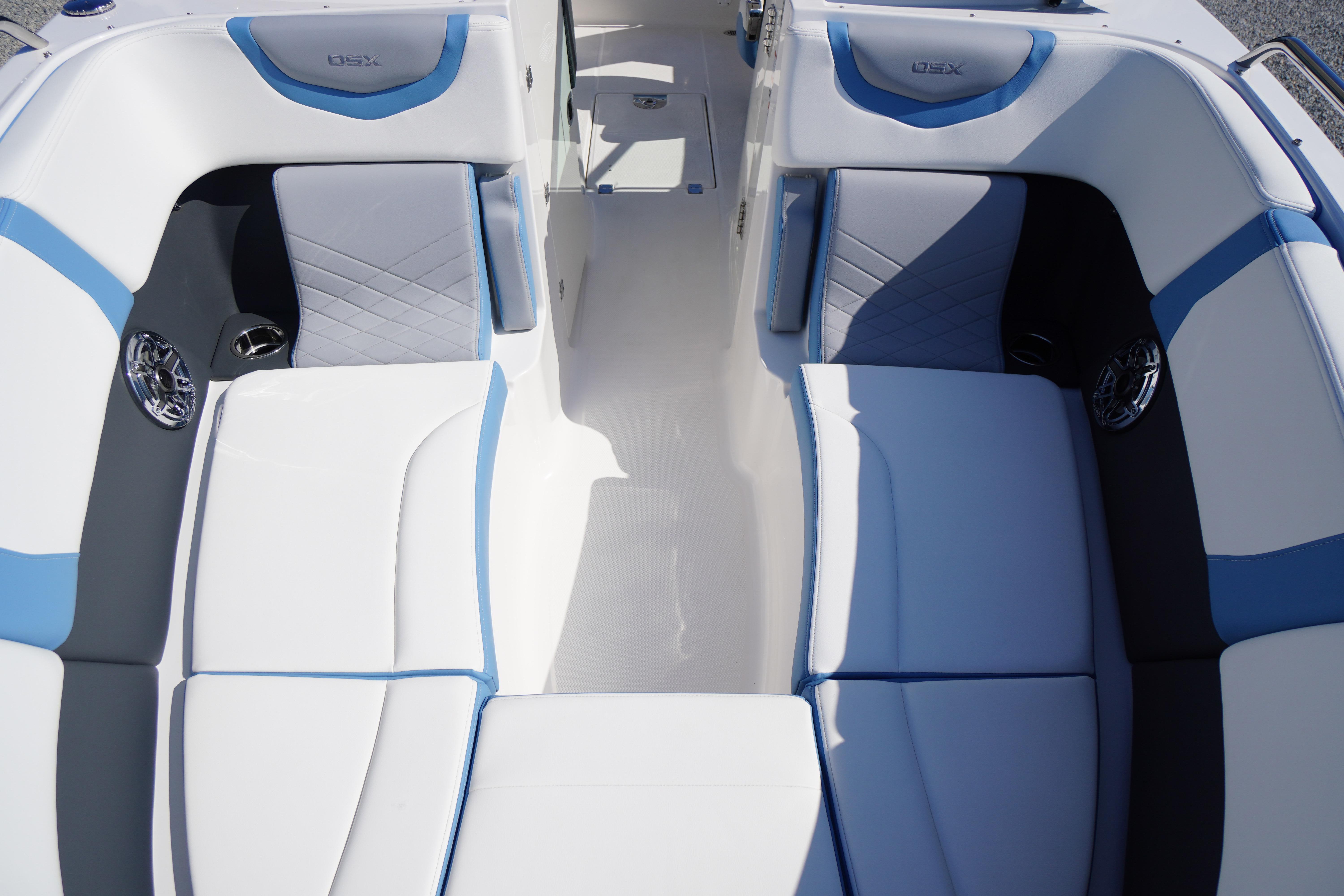 2026 Chaparral 270 OSX boat interior with stylish blue and white seating.