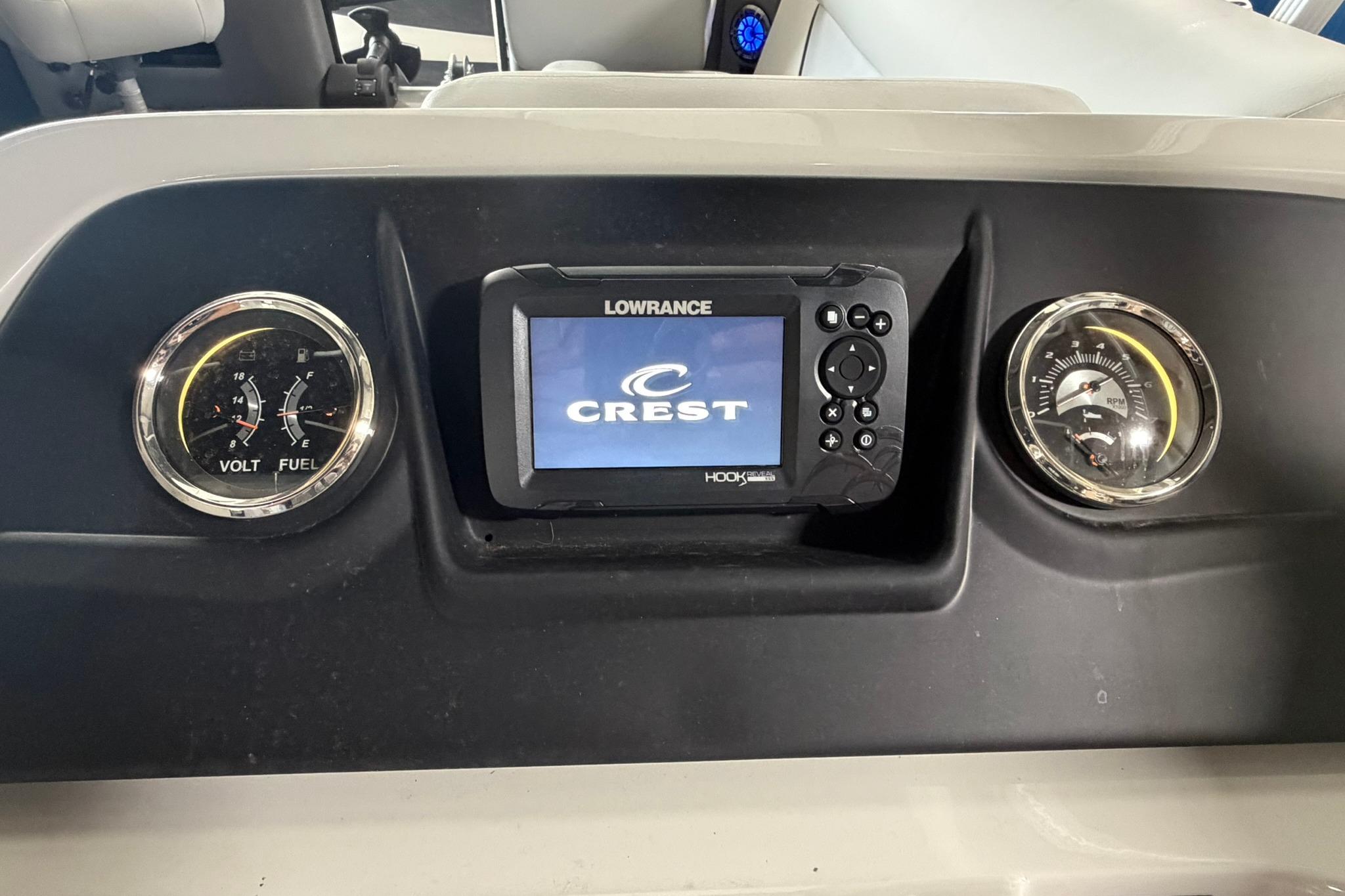 Dashboard of 2023 Crest Classic LX 200 with gauges and Lowrance display.