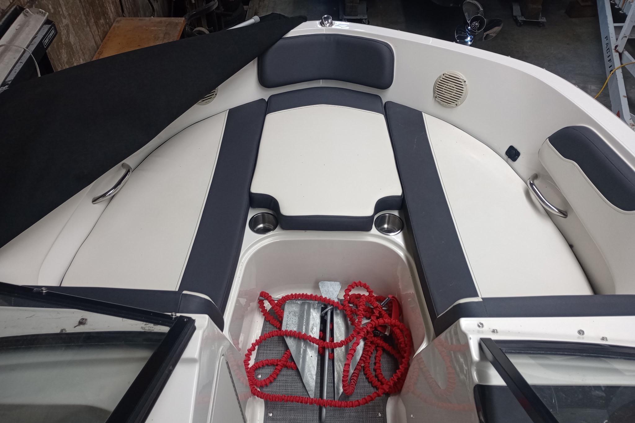 2022 Bayliner VR5 Bowrider I/O interior with seating and red rope in storage area.