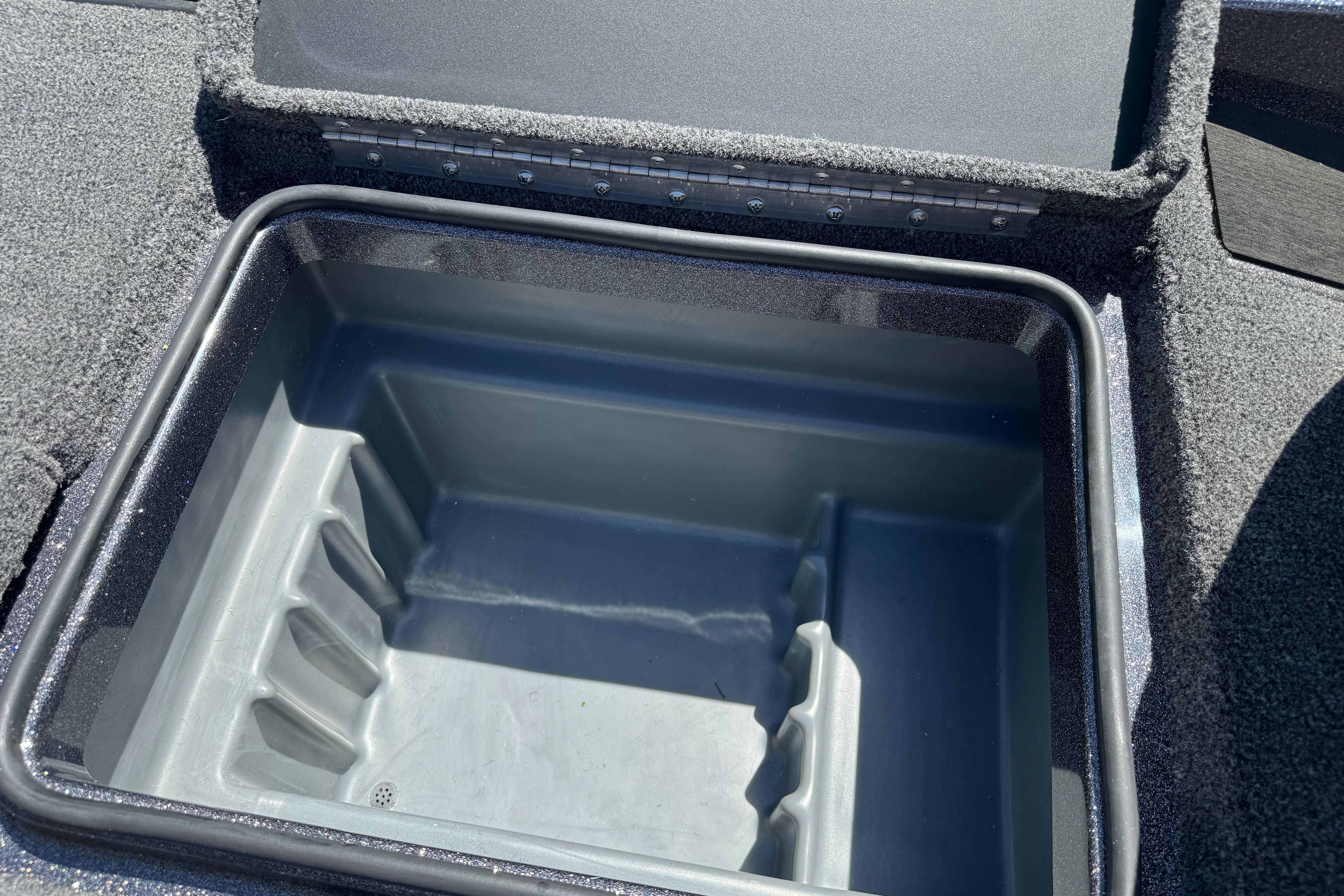 Open storage compartment in 2026 Triton 18 TrX boat, featuring durable interior design.