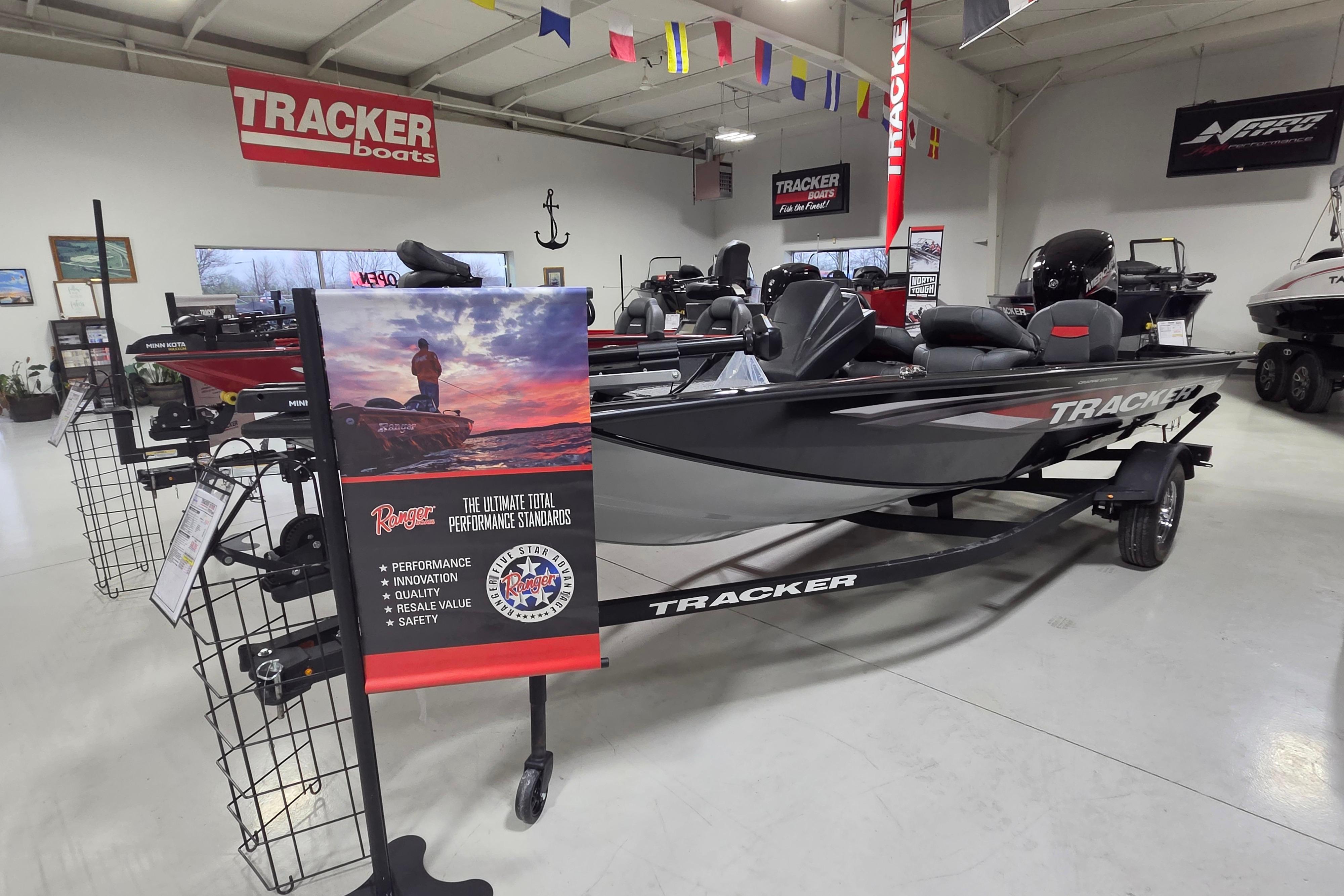 2026 Tracker Pro Team 175 Crappie Edition boat displayed in showroom with promotional signage.