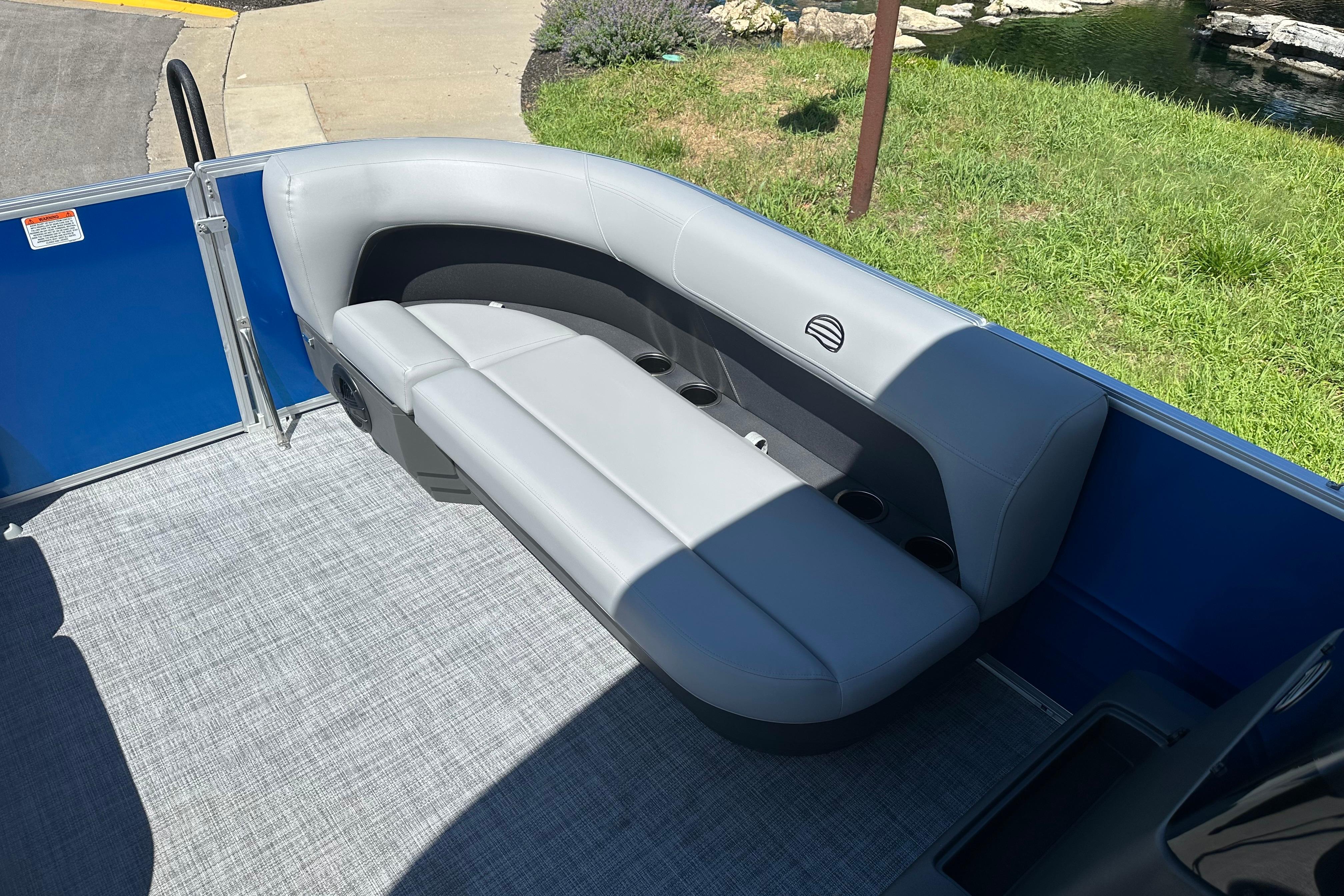2026 Sun Tracker Party Barge 16 DLX with gray seating and blue paneling.