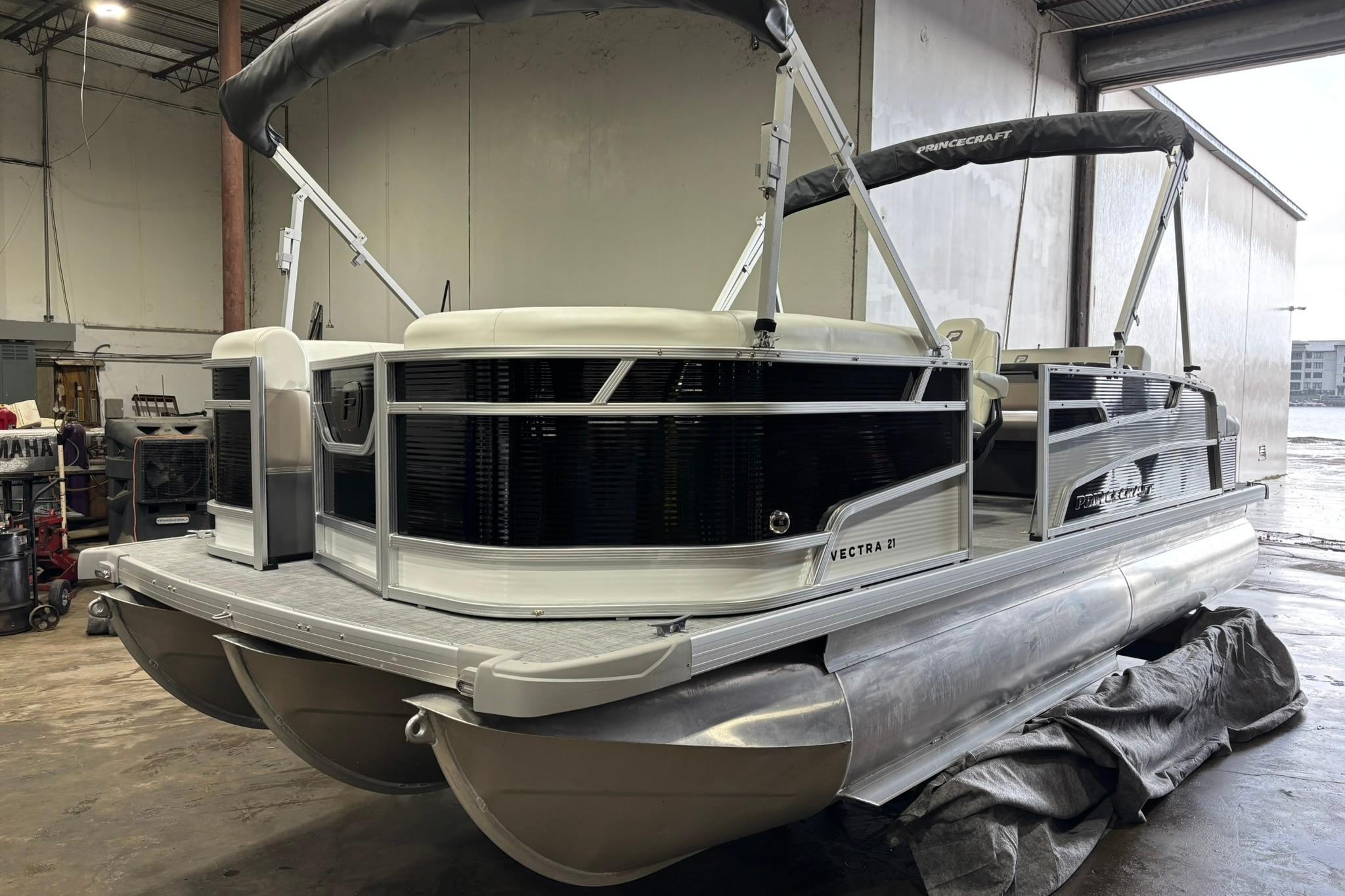2025 Princecraft Vectra 21 RL pontoon boat in a warehouse setting.
