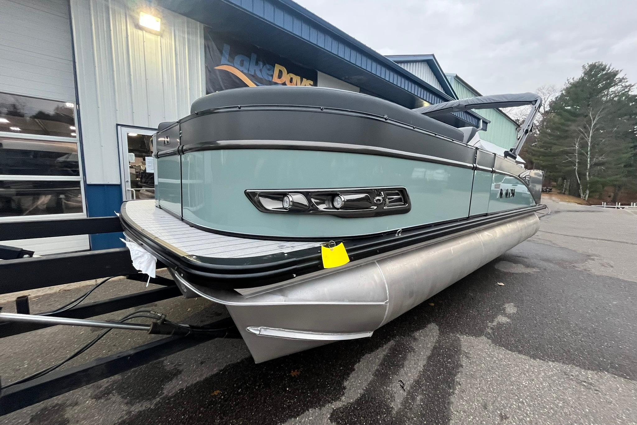 2026 Avalon Catalina Versatile Rear Lounger pontoon boat parked outside a building.