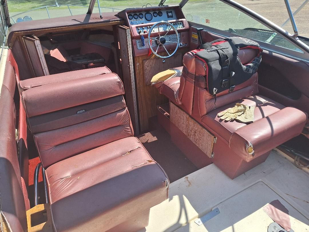 Interior of a 1986 Sea Ray Weekender 230 with red leather seats.