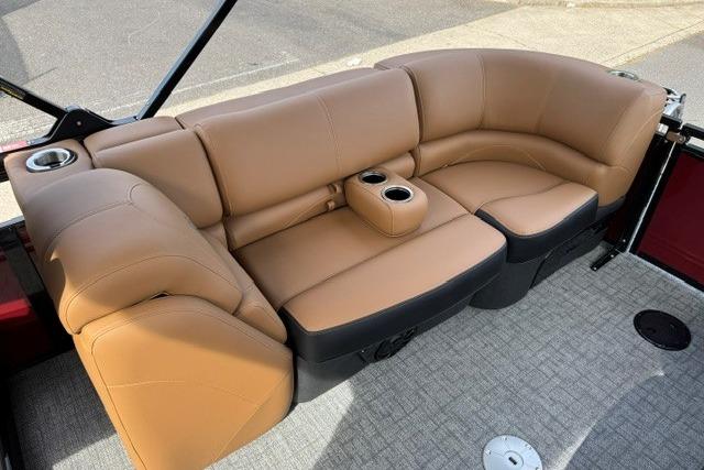 Luxurious tan seating on 2026 Regency 230 DL boat, featuring cup holders and modern design.