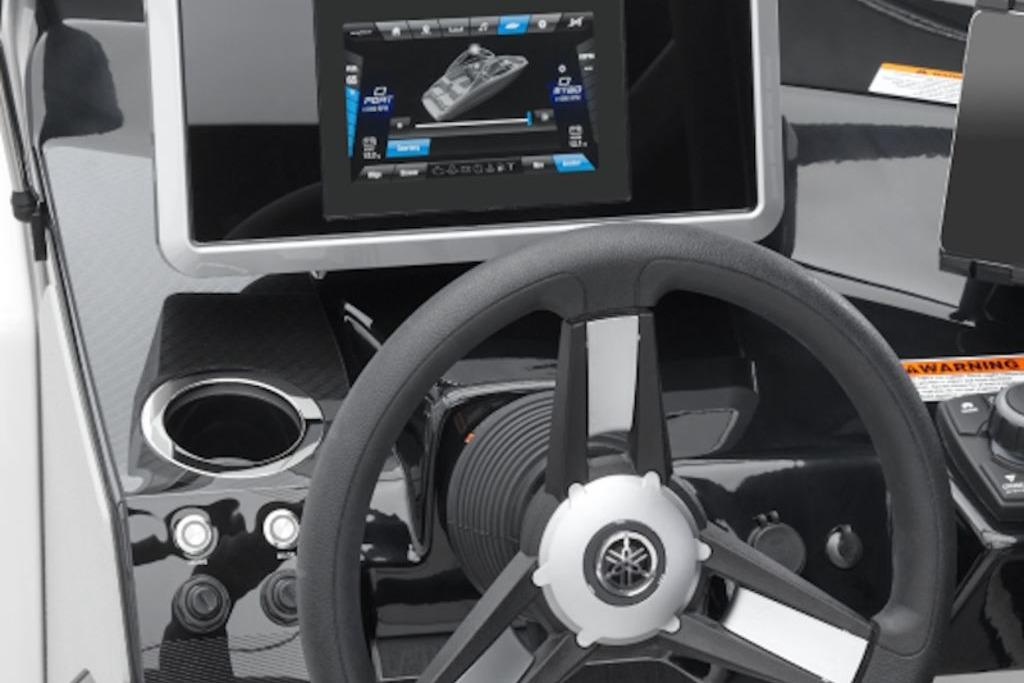 Steering wheel and dashboard of 2026 Yamaha Boats SX250 with touchscreen display.