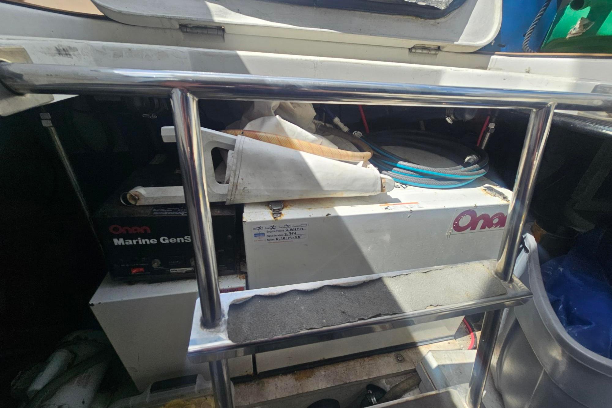 2002 Carver 450 Voyager Pilothouse engine compartment with Onan Marine Generator.
