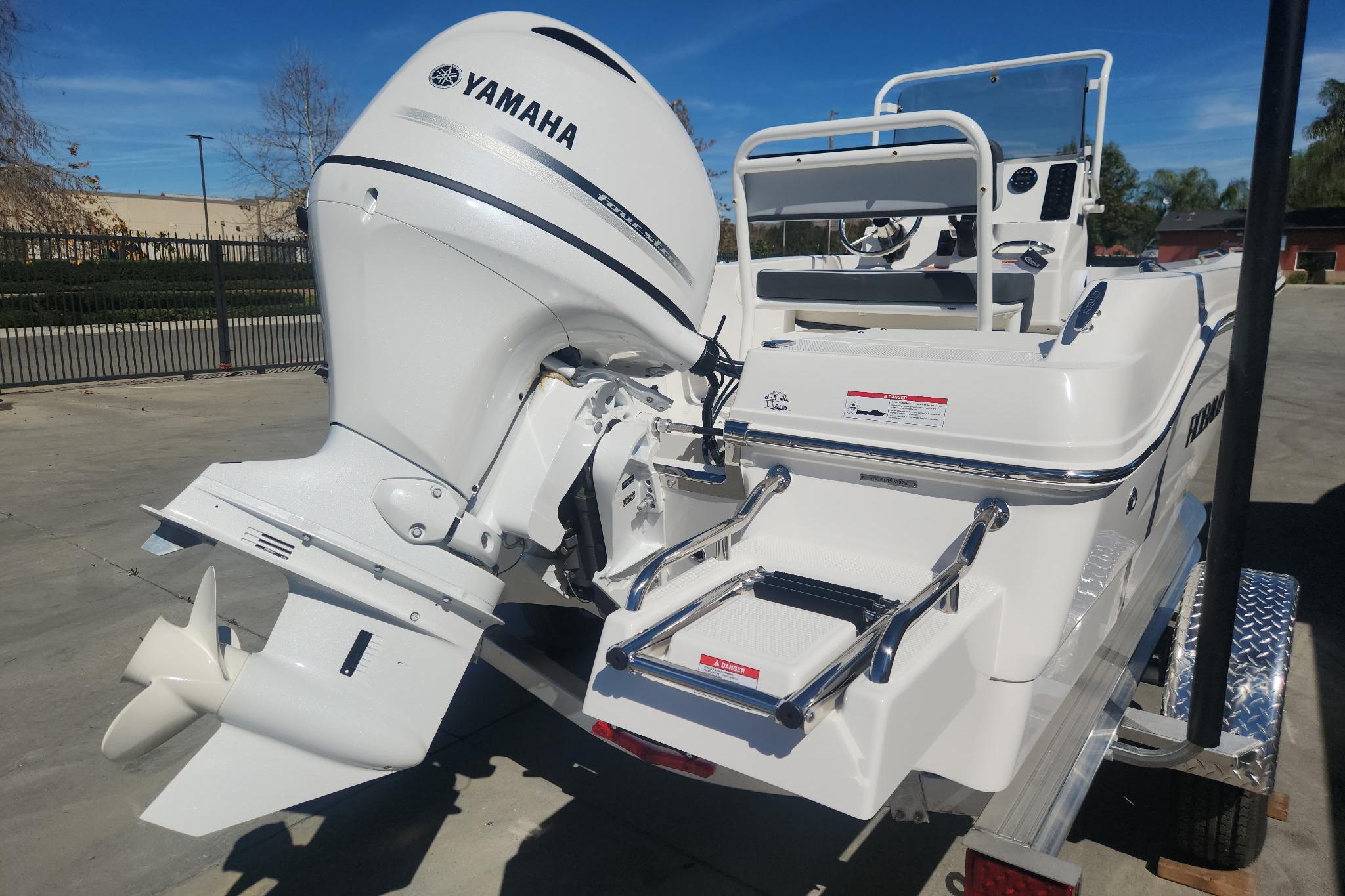 2026 Robalo R160 Center Console boat with Yamaha outboard motor on trailer.