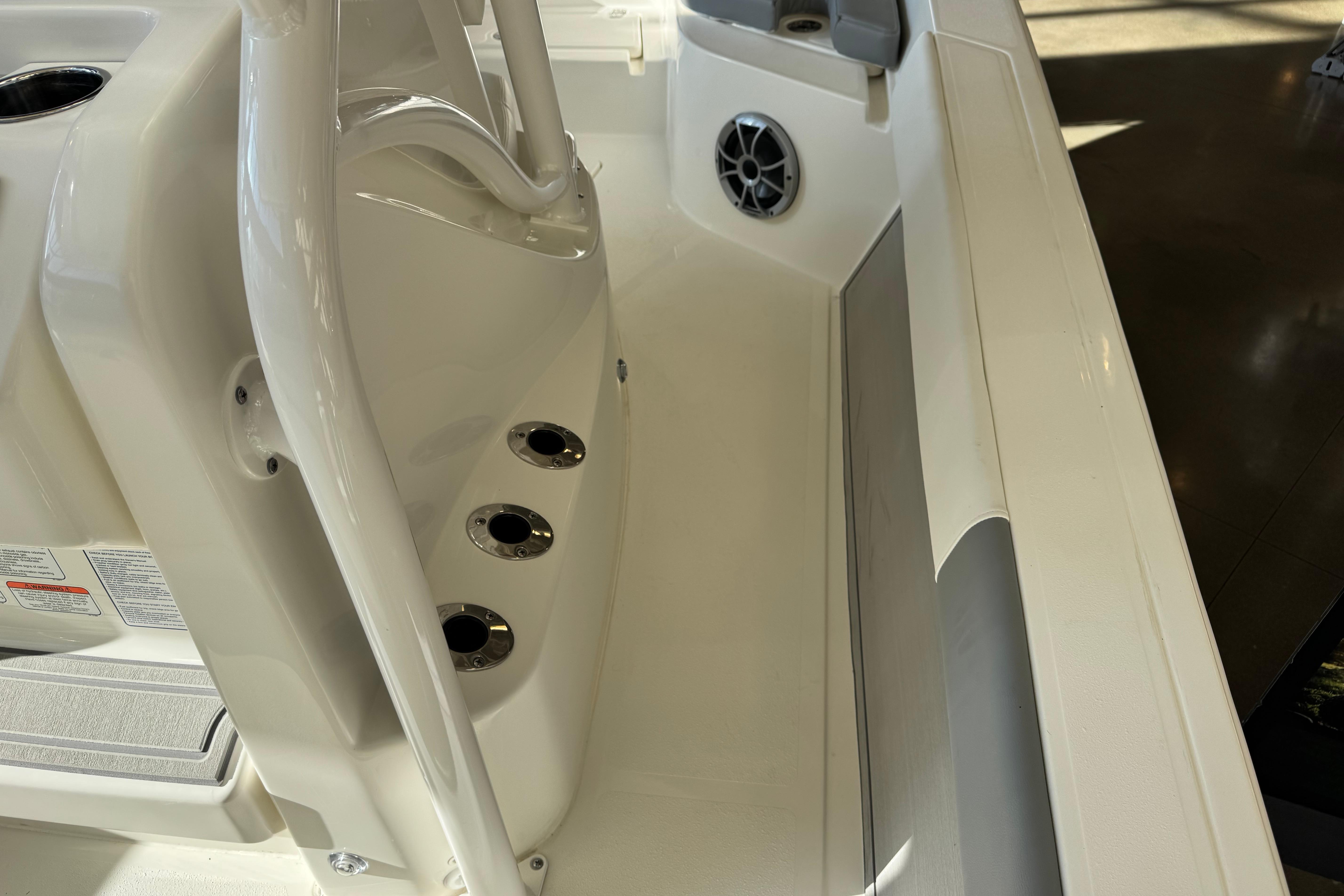 Interior view of 2026 Mako 24 APEX boat, featuring seating and speaker details.