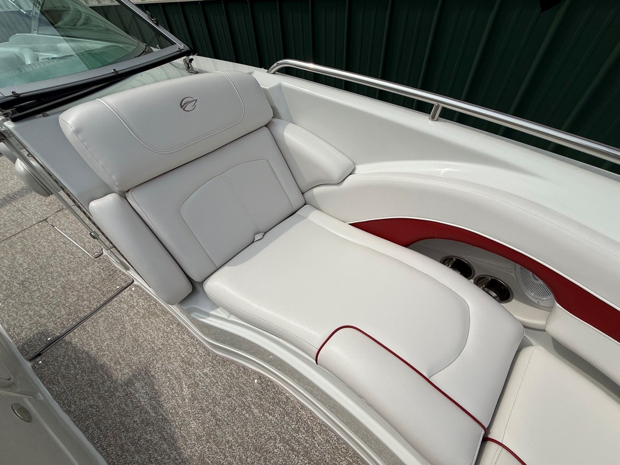The image shows the white upholstery of a 2012 Crownline 252 EX with red accents.