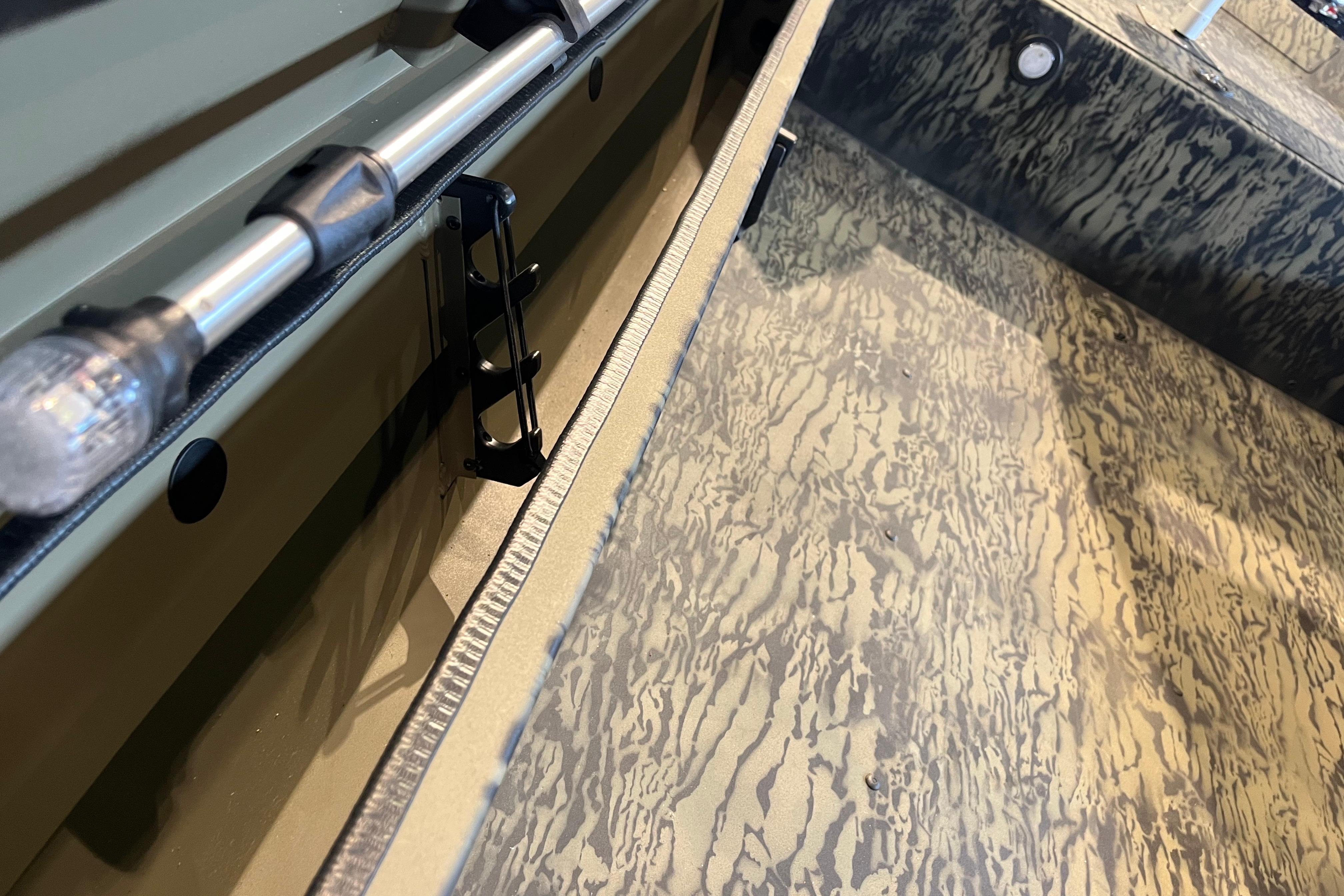 Interior view of 2026 Tracker Grizzly 1654 T Sportsman boat with camouflage flooring.