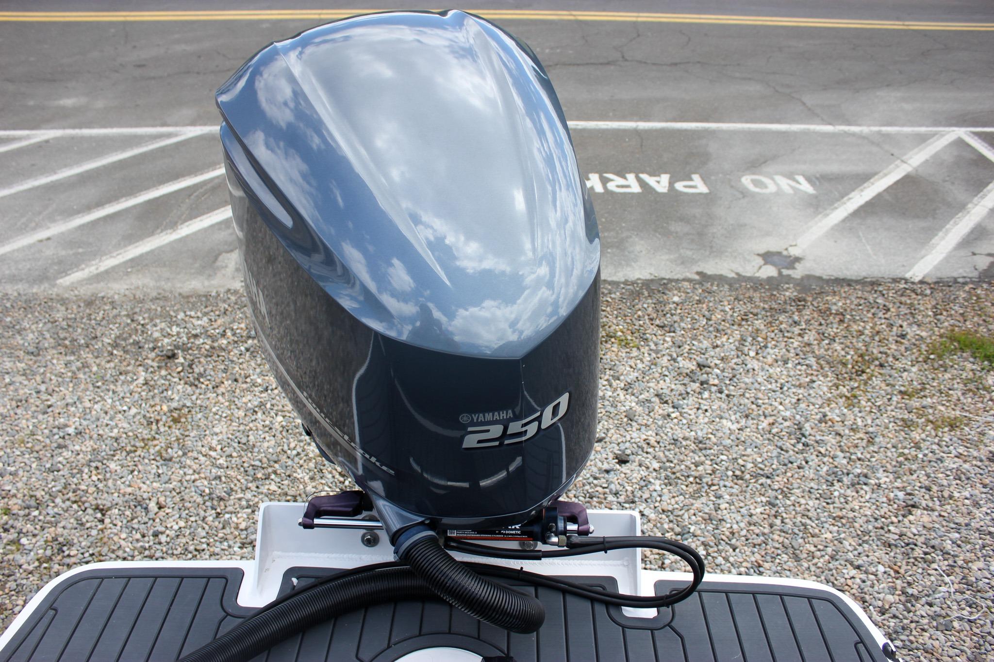 Yamaha 250 outboard motor on 2022 NorthCoast 235 Cabin boat, reflecting sky and clouds.
