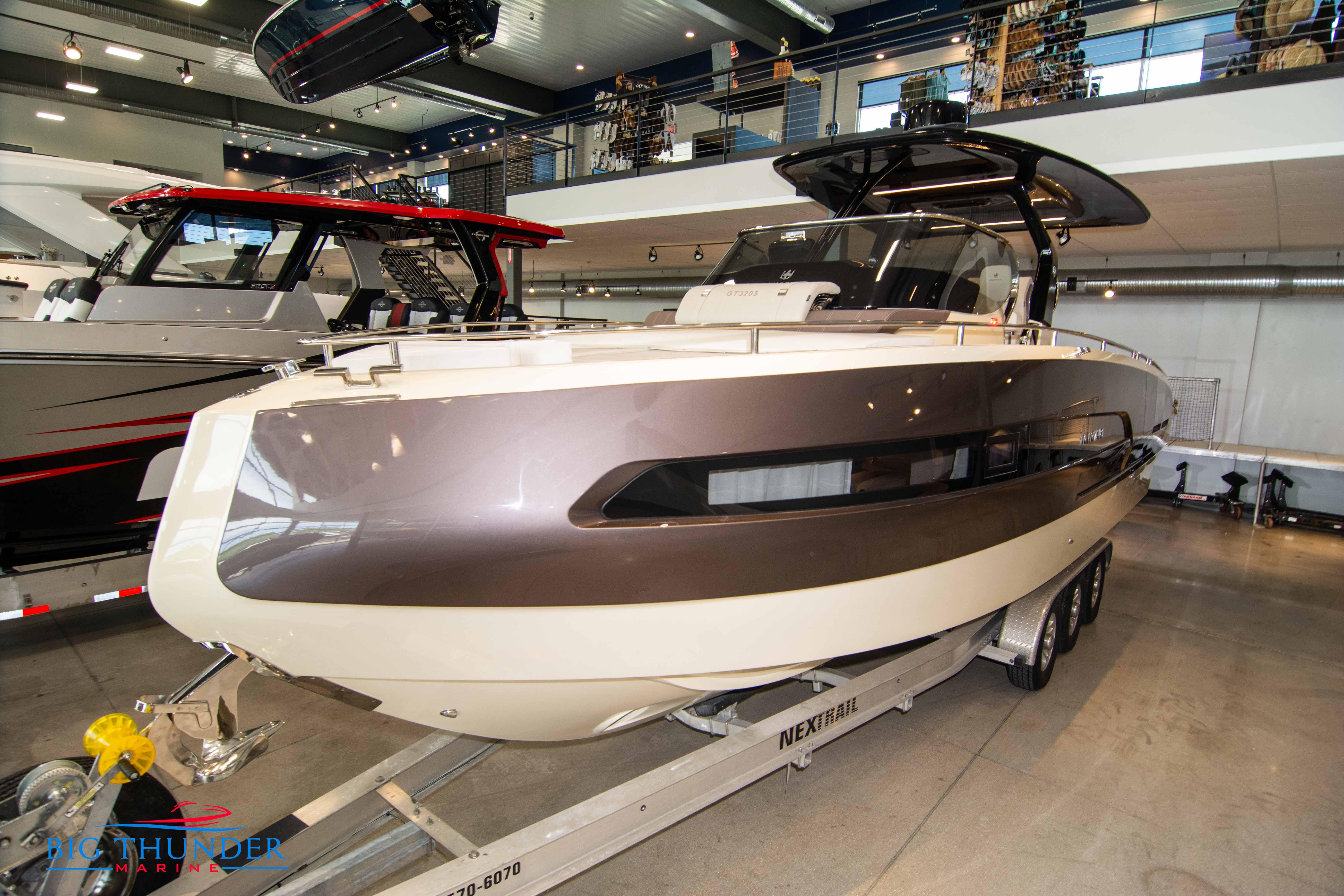 2024 Invictus GT320S luxury boat on display in a showroom.