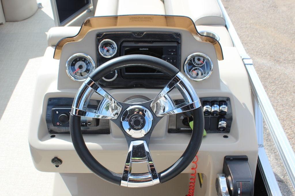 Steering console of 2021 Avalon VLS Quad Lounge 22 FT boat with gauges and controls.