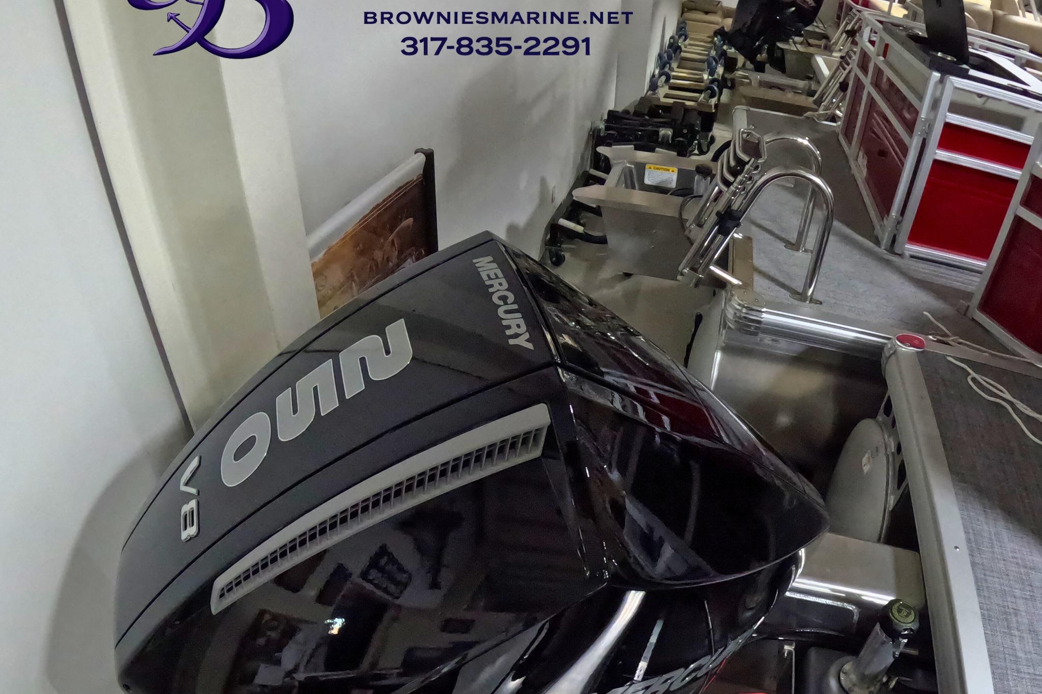 2026 Sun Tracker Party Barge 24 XP3 with Mercury V8 engine in showroom.