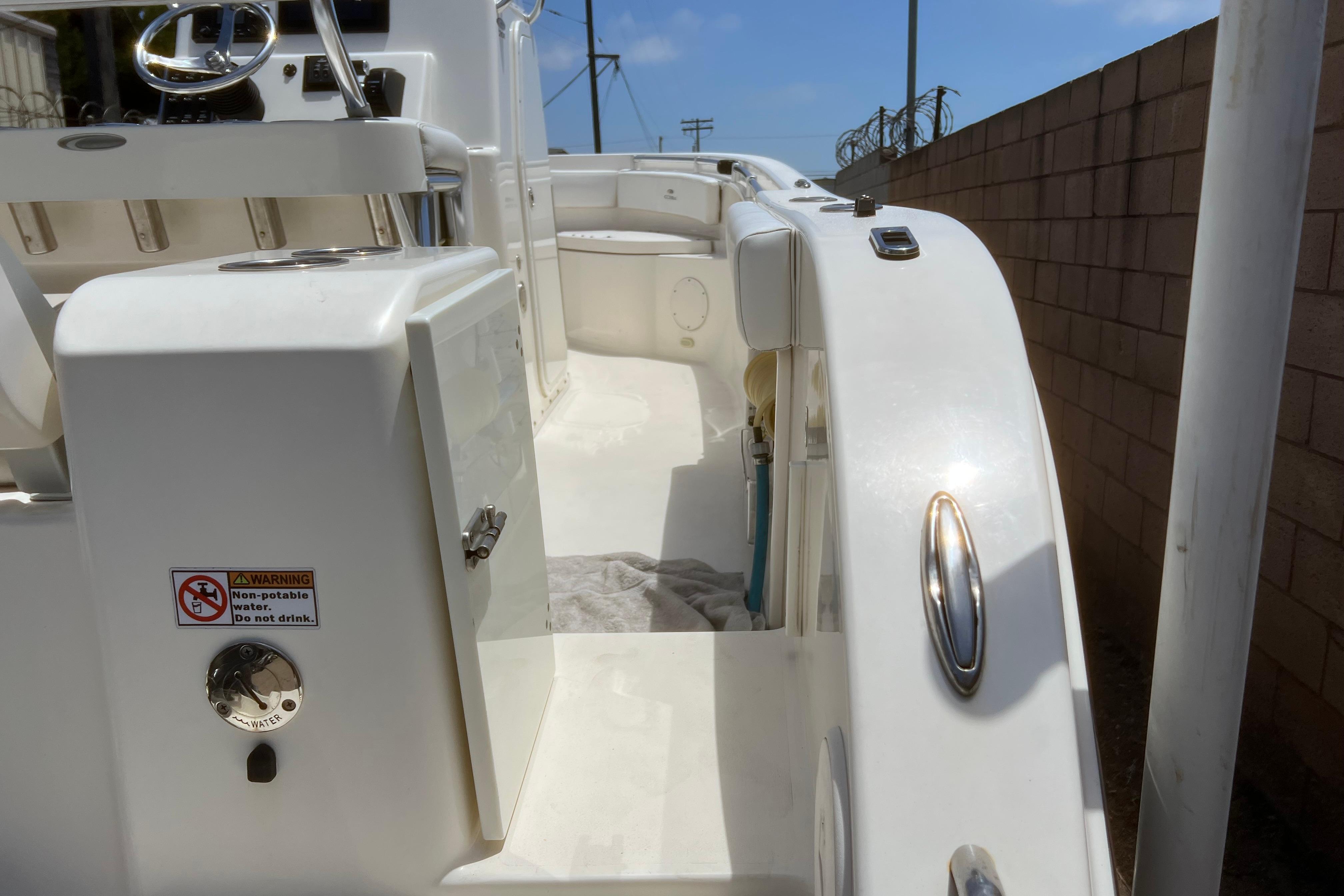 2018 Cobia 201 Center Console boat interior with steering wheel and storage compartments.