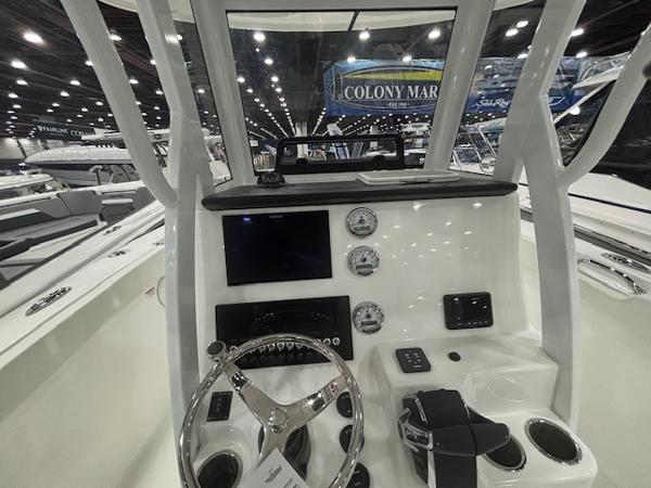 2025 Sea Pro 262 Offshore boat dashboard with steering wheel and gauges at a boat show.