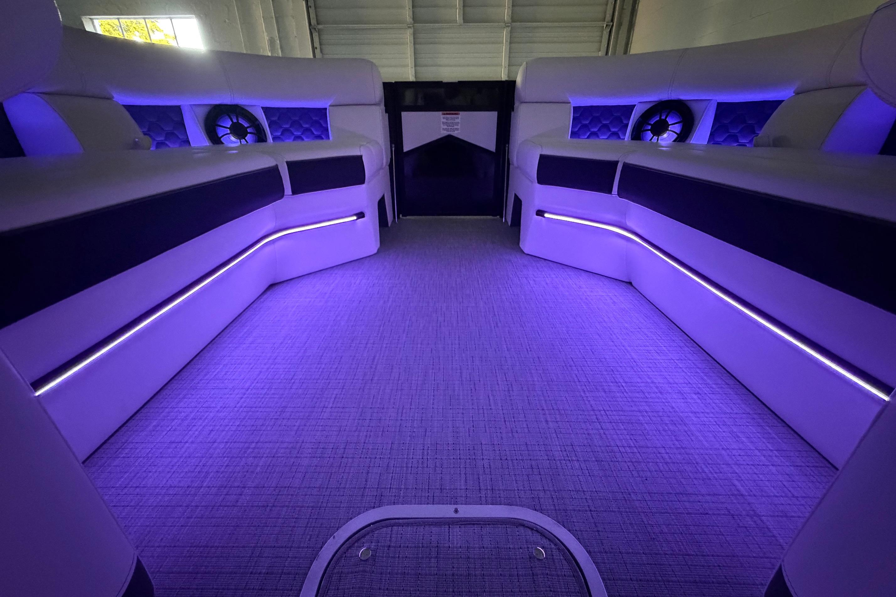 Luxurious interior of 2026 South Bay 525SB2 boat with ambient purple lighting.