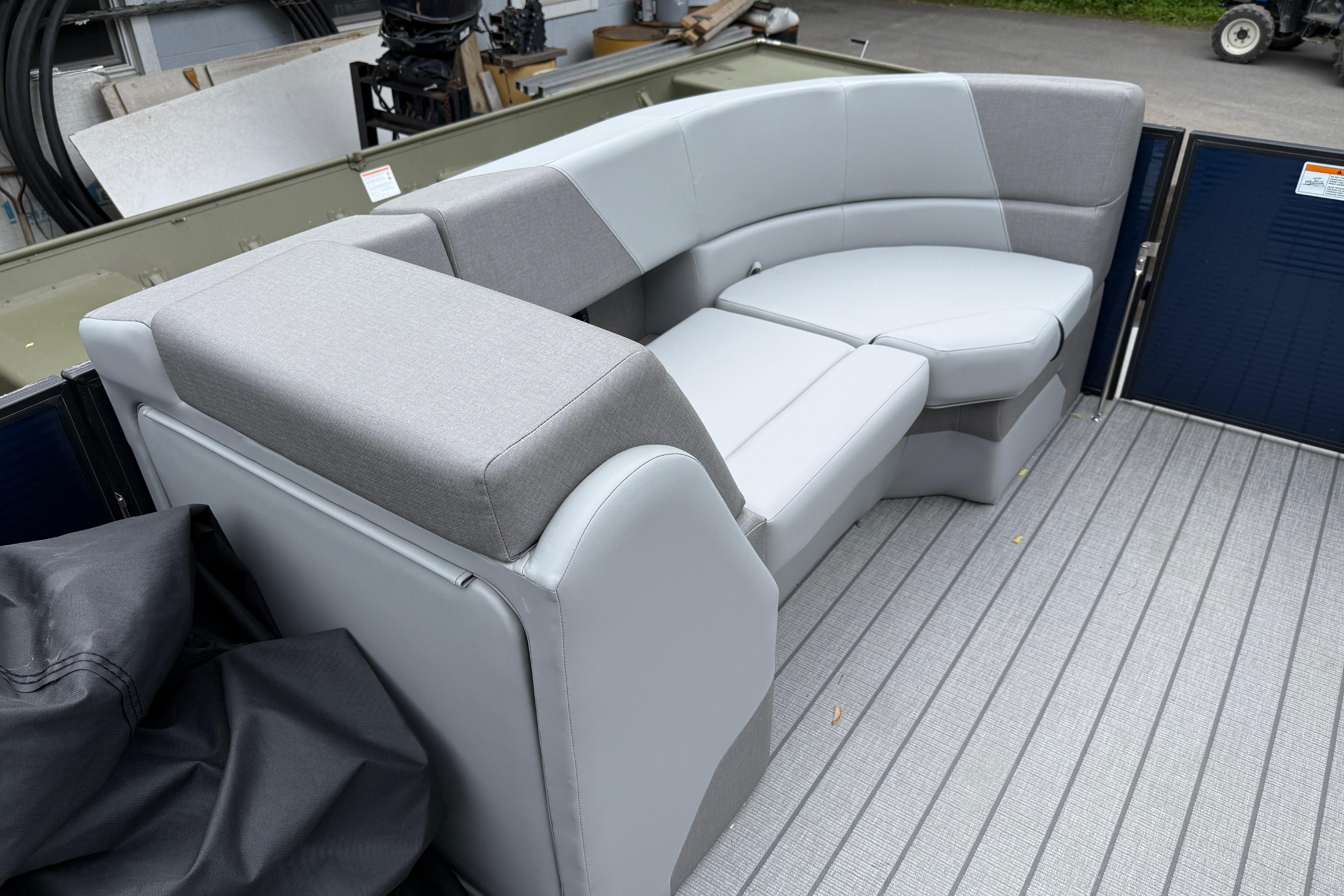 2027 Manitou Aurora RF 23 boat interior with gray seating and flooring.