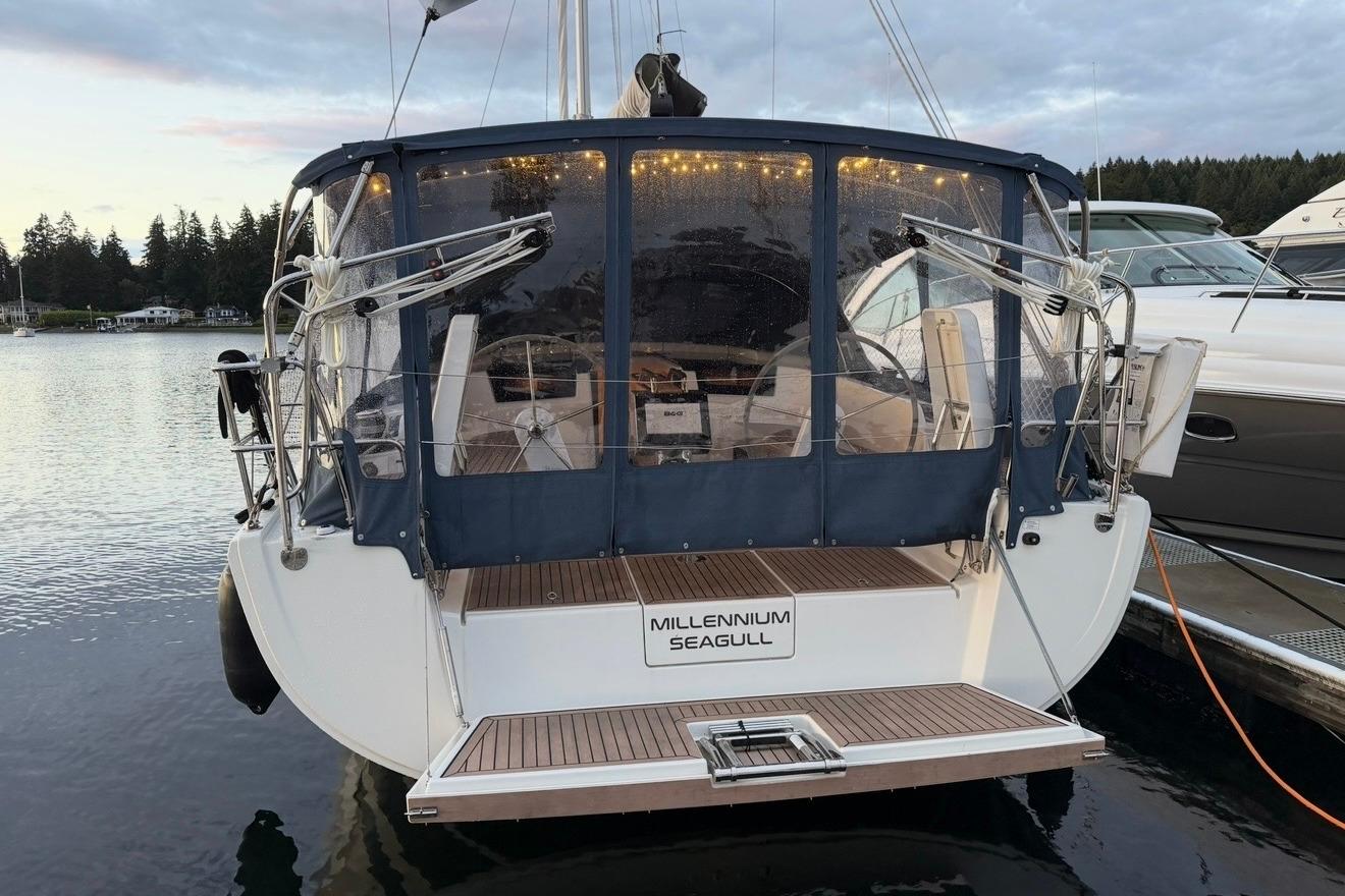 2022 Hanse 418 sailboat docked, featuring a covered cockpit and elegant design.