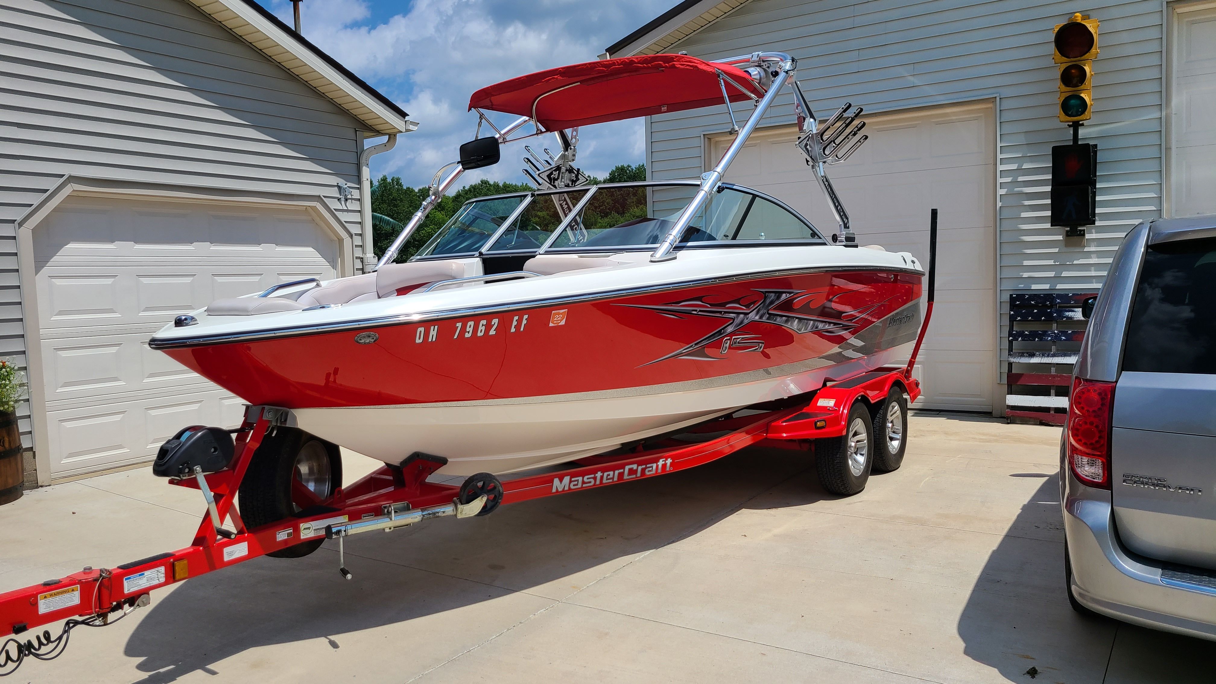 2007 MasterCraft X-15 boat on red trailer in driveway.