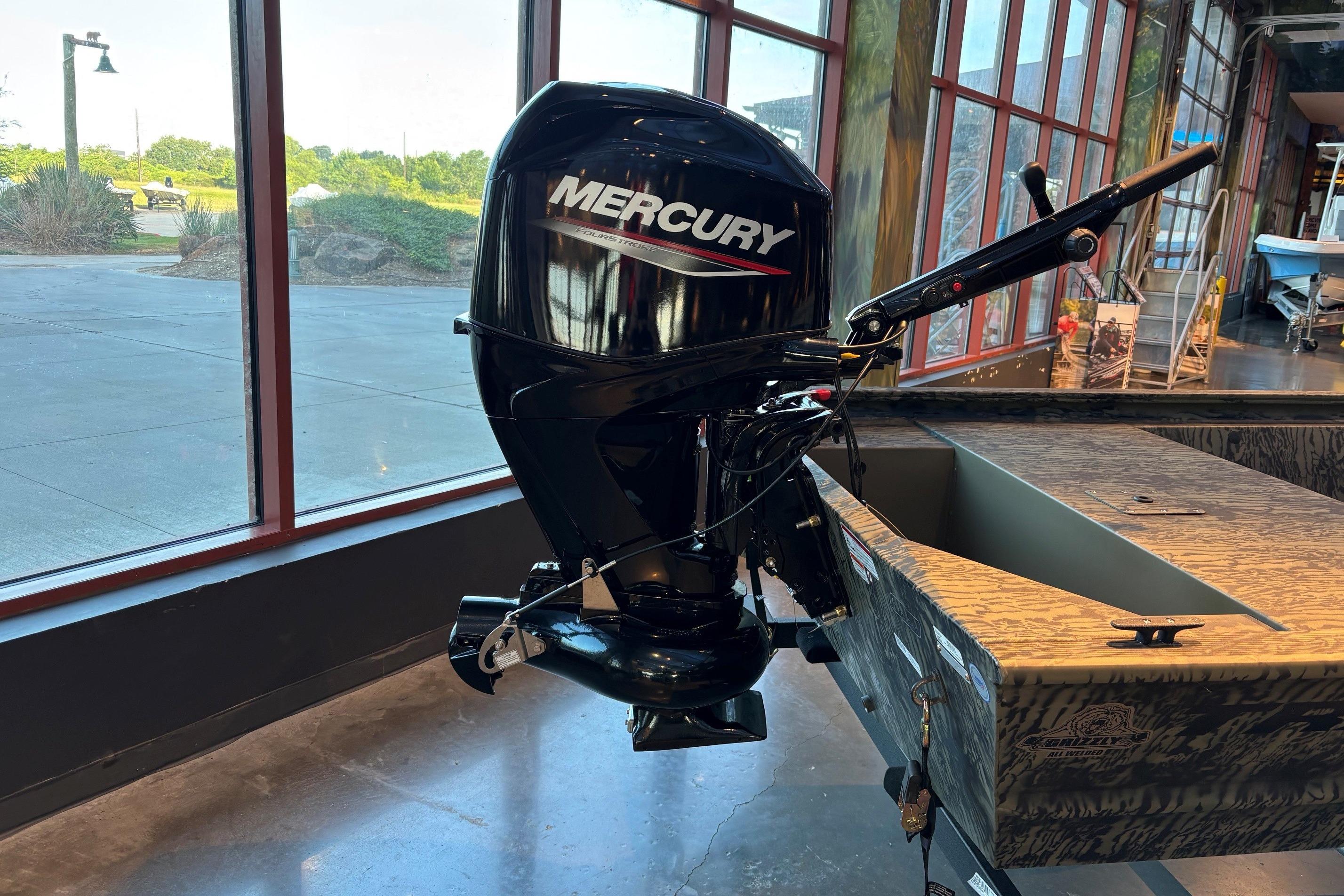 2026 Tracker Grizzly 1648 Utility boat with Mercury outboard motor in showroom display.