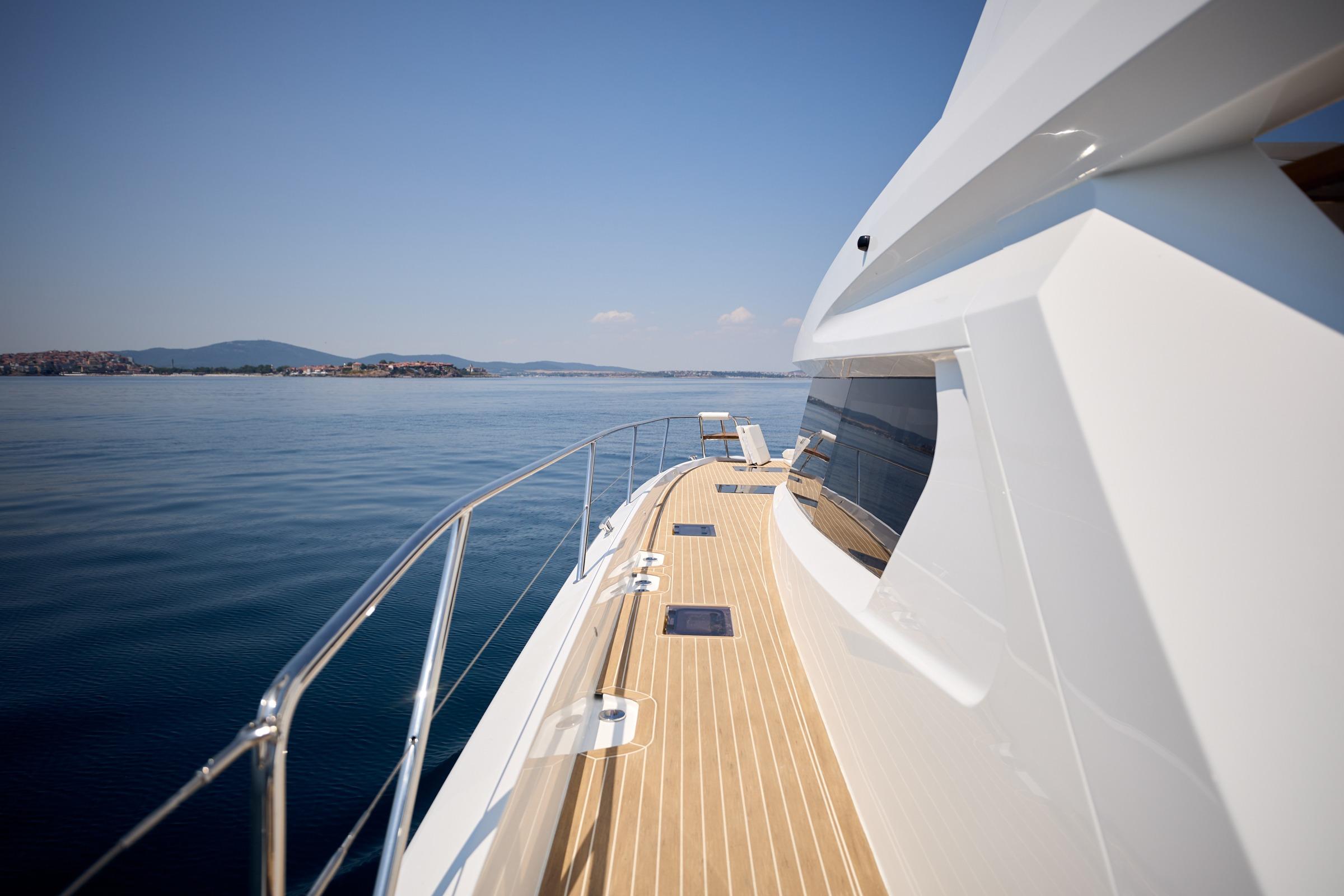 Sleek 2025 Omaya 50 Power Catamaran cruising on calm waters, showcasing modern design.