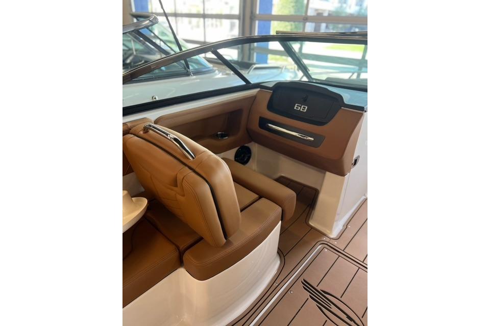 2025 Chaparral 247 SSX boat interior with tan seating and sleek dashboard design.