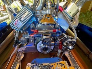 Close-up of a shiny boat engine with blue and red accents.