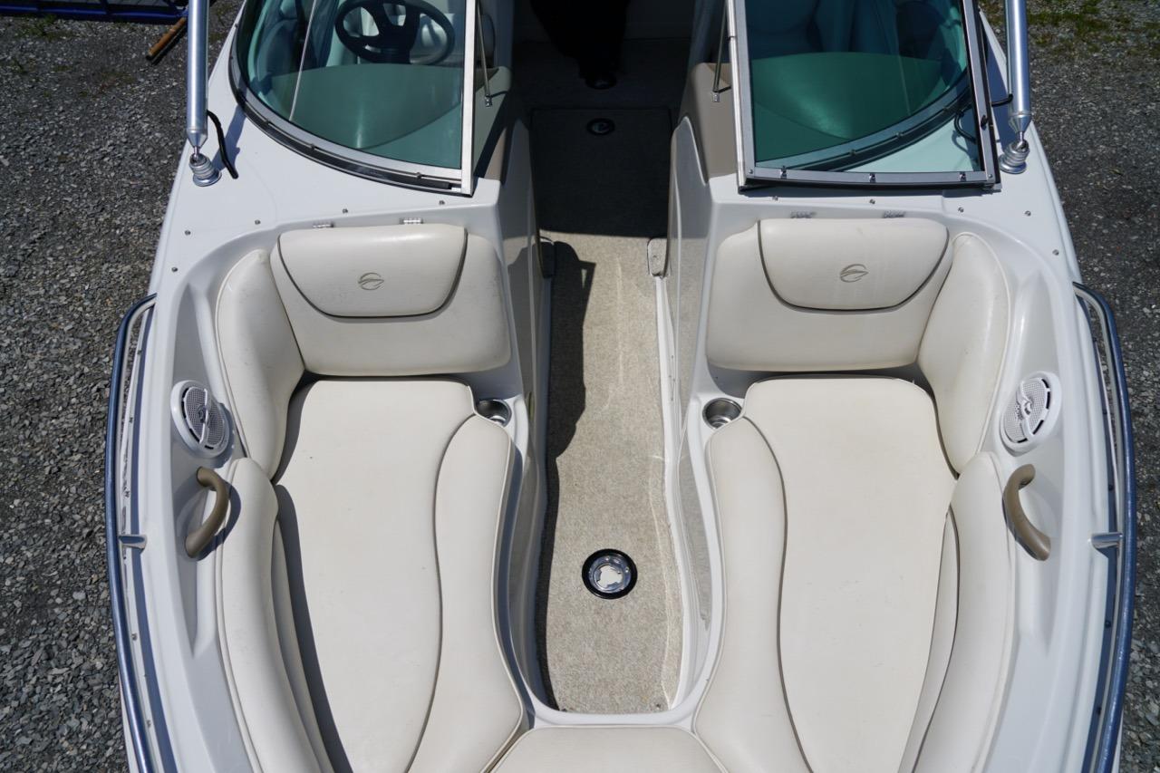 2004 Crownline 216 LS boat interior with white seating and open windshield.