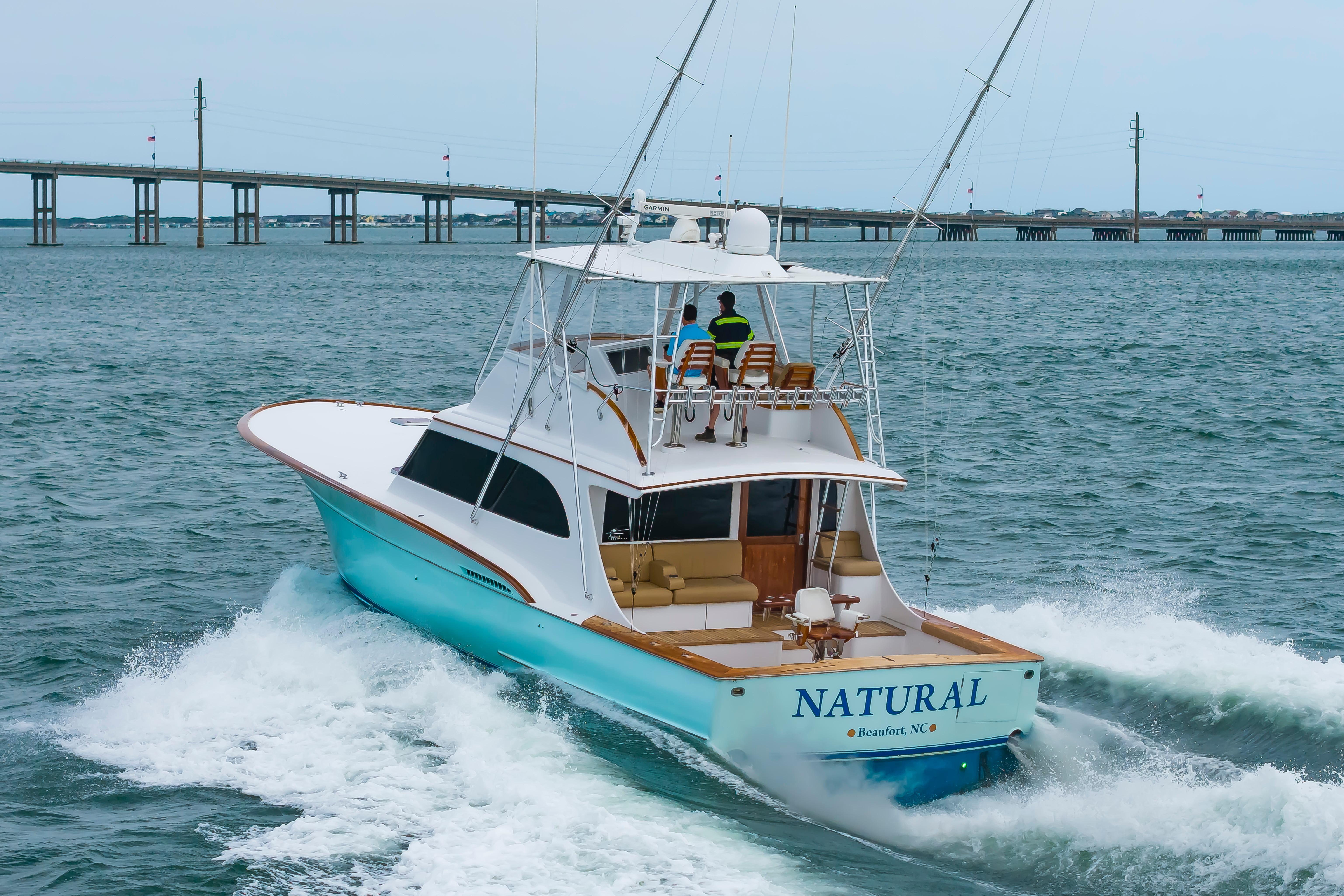 Custom Carolina Scarborough 56 Convertible yacht cruising near a bridge, 1993 model.