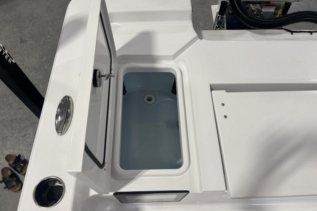 Open storage compartment on 2026 Sportsman Masters 247 Bay Boat, showcasing interior design.