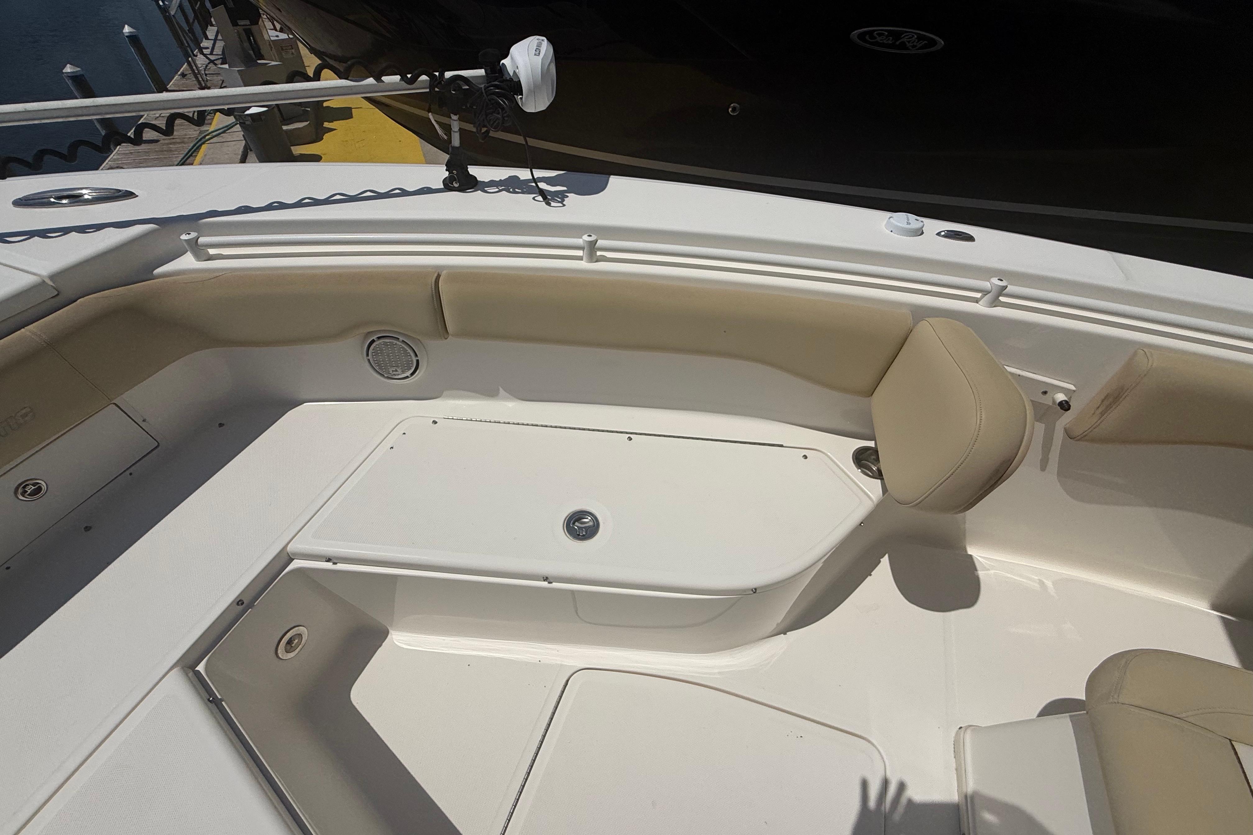 2019 Key West Billistic 281 Center Console boat interior with beige seating and storage compartments.
