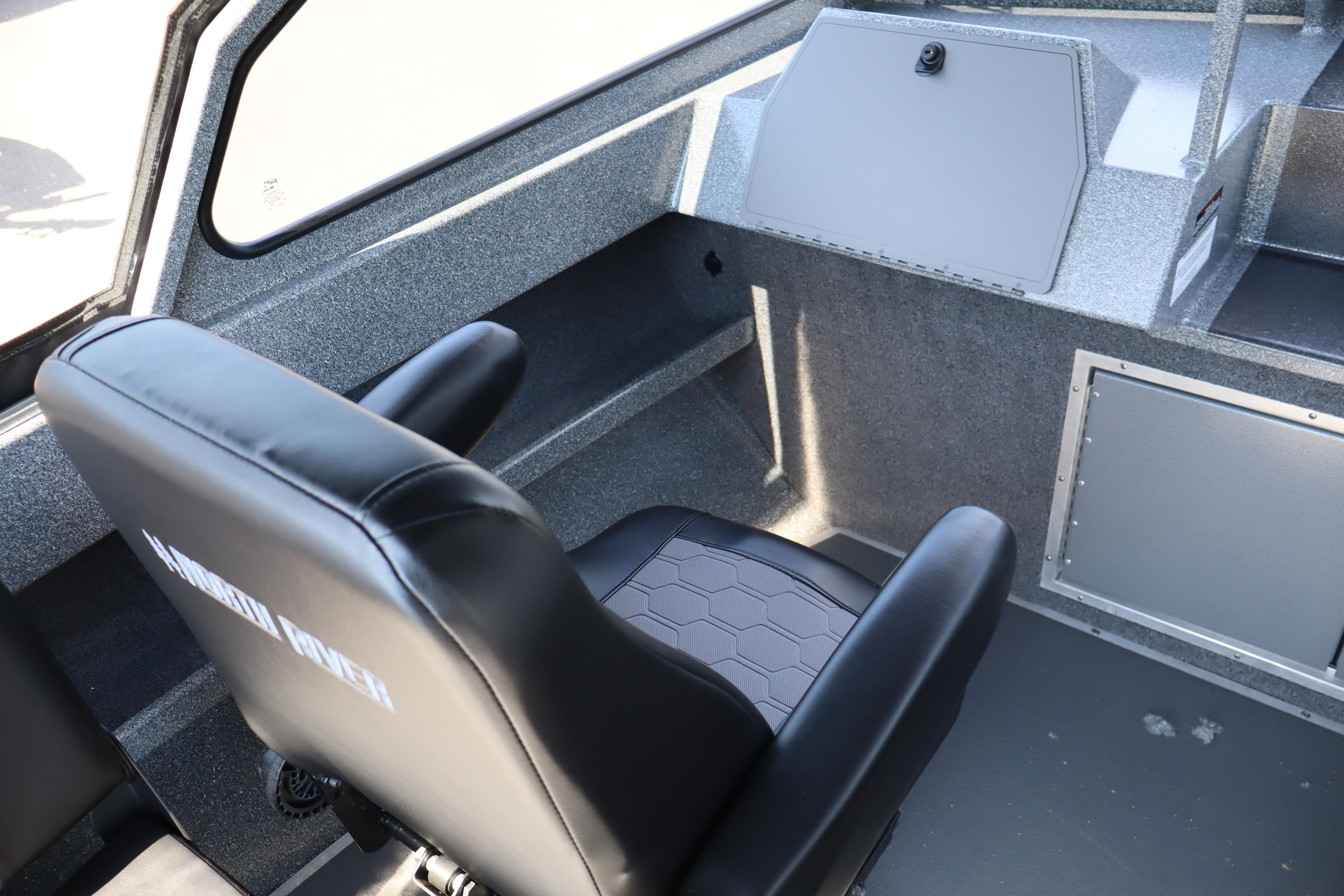 Interior of 2025 NorthRiver SEAHAWK boat with black seating and modern design.