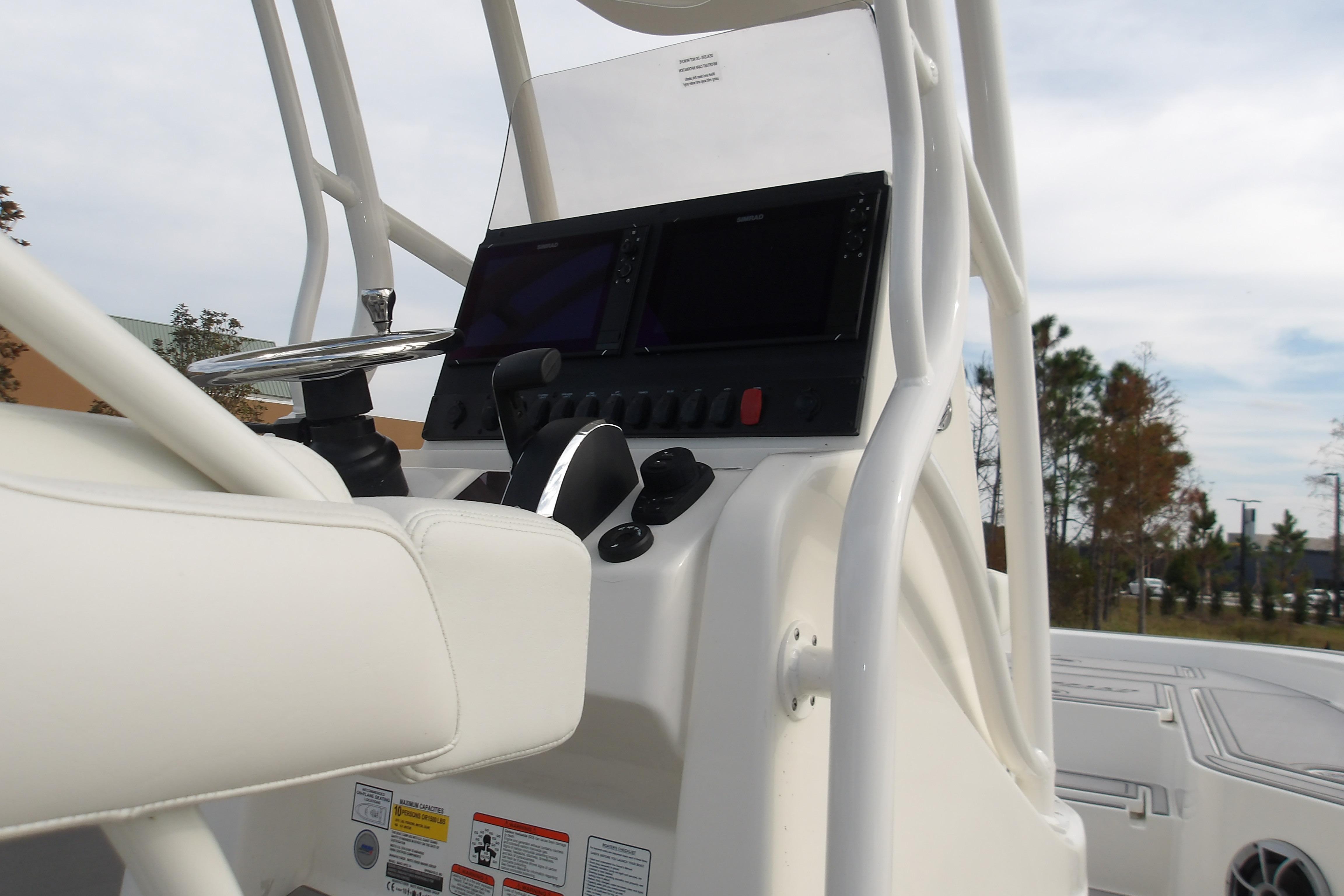 2026 Mako 24 APEX boat console with steering wheel and control panel.