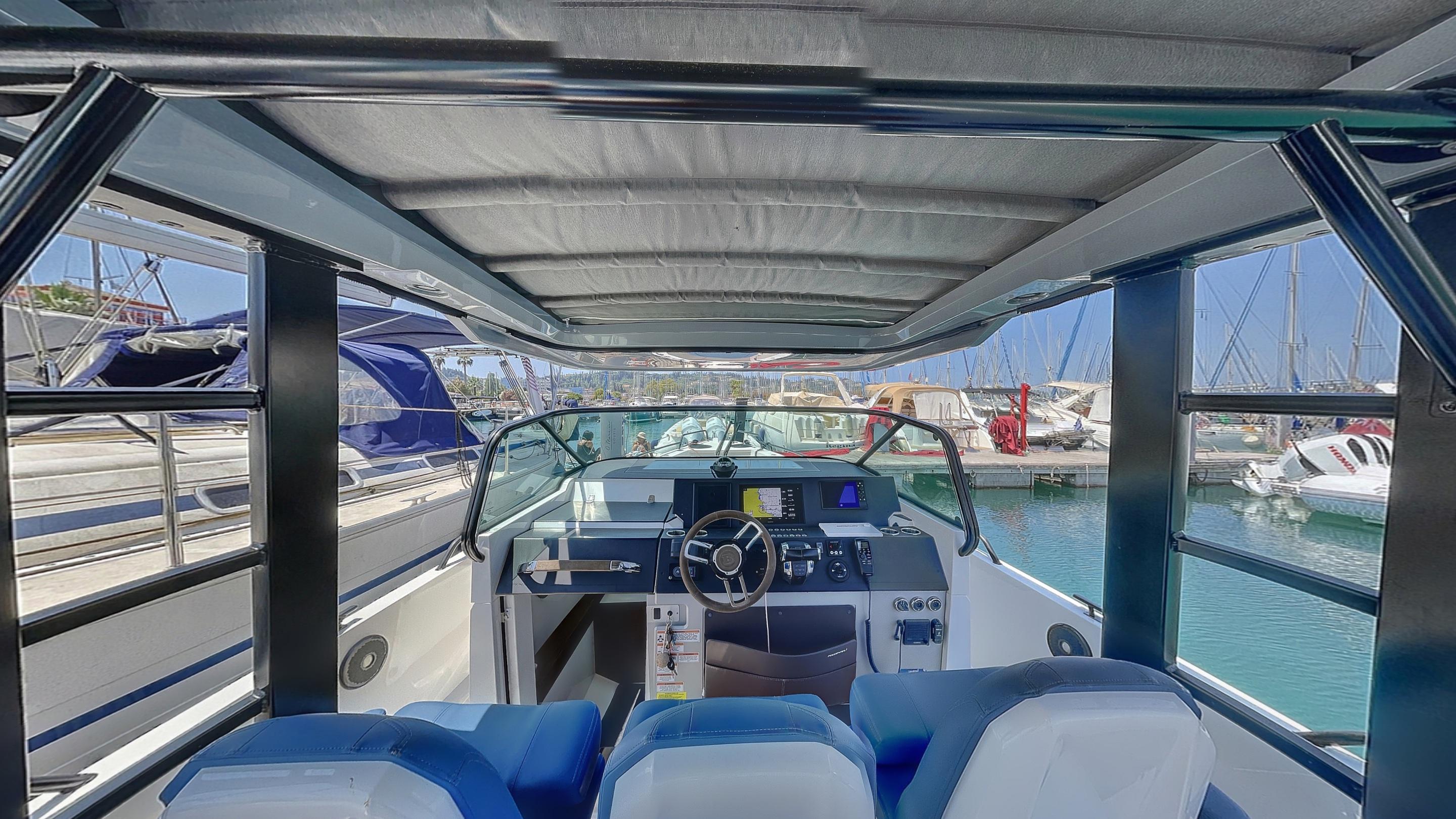 2019 Axopar 37 ST Brabus Line boat interior with modern dashboard and seating at marina.