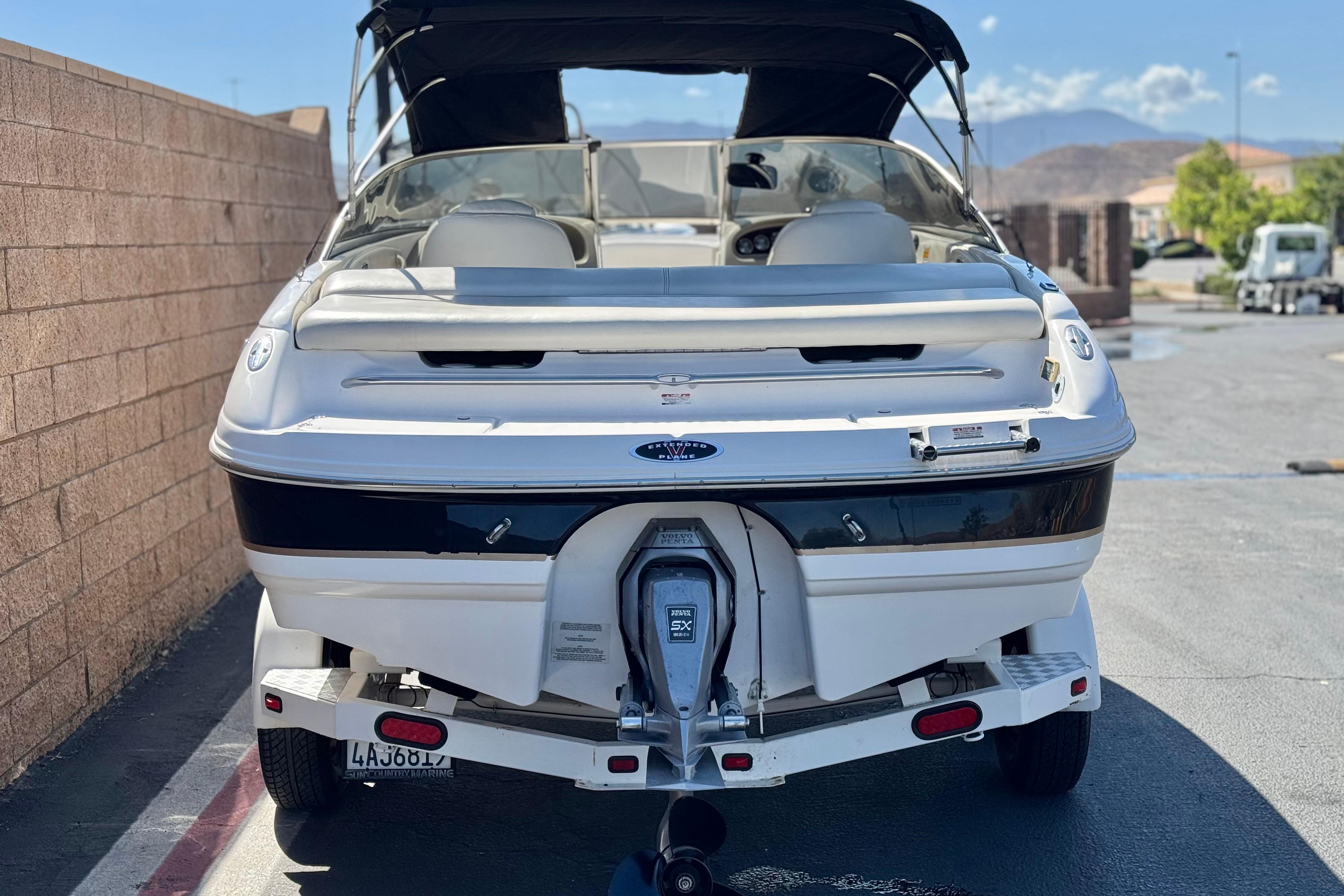 2002 Chaparral 186 SSi boat on trailer, parked outdoors.