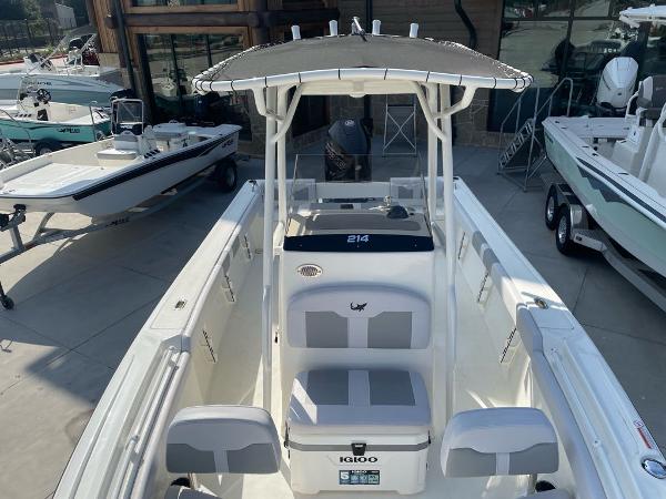 2024 Mako 214 CC center console boat in a showroom display.