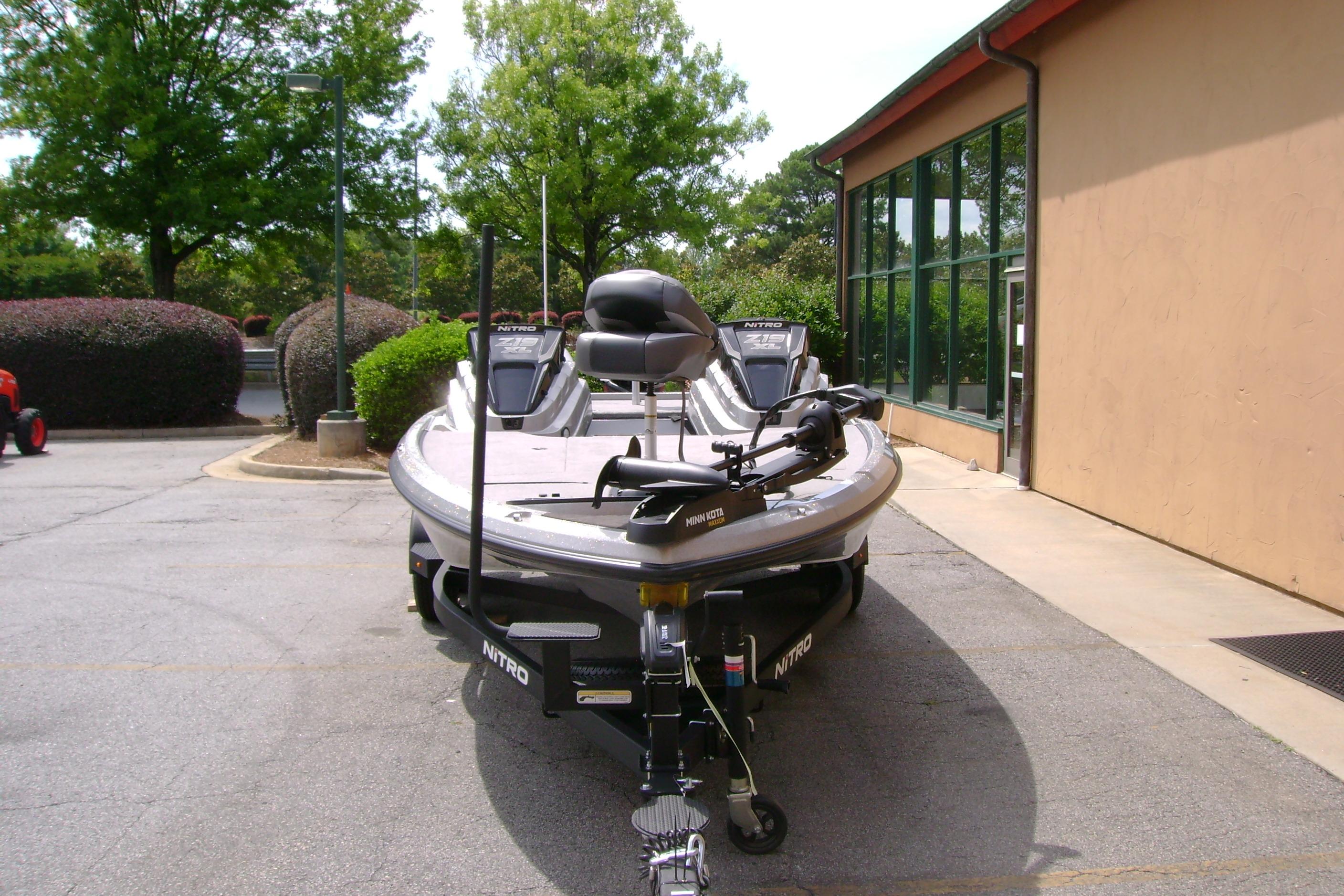 2026 Nitro Z19 XL boat parked outdoors near a building, showcasing sleek design and modern features.