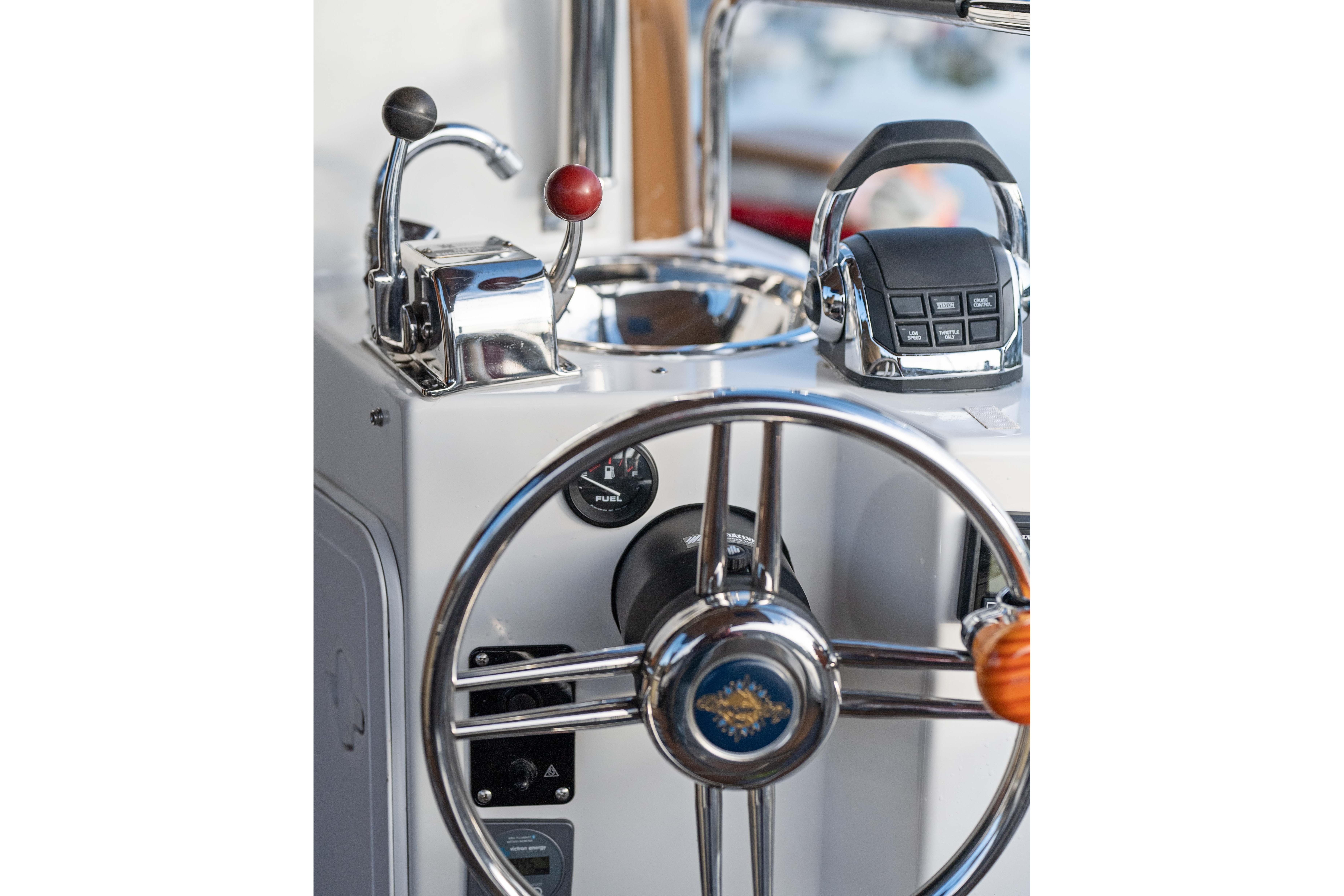 2014 Ranger Tug R-31 CB helm with steering wheel and control levers.