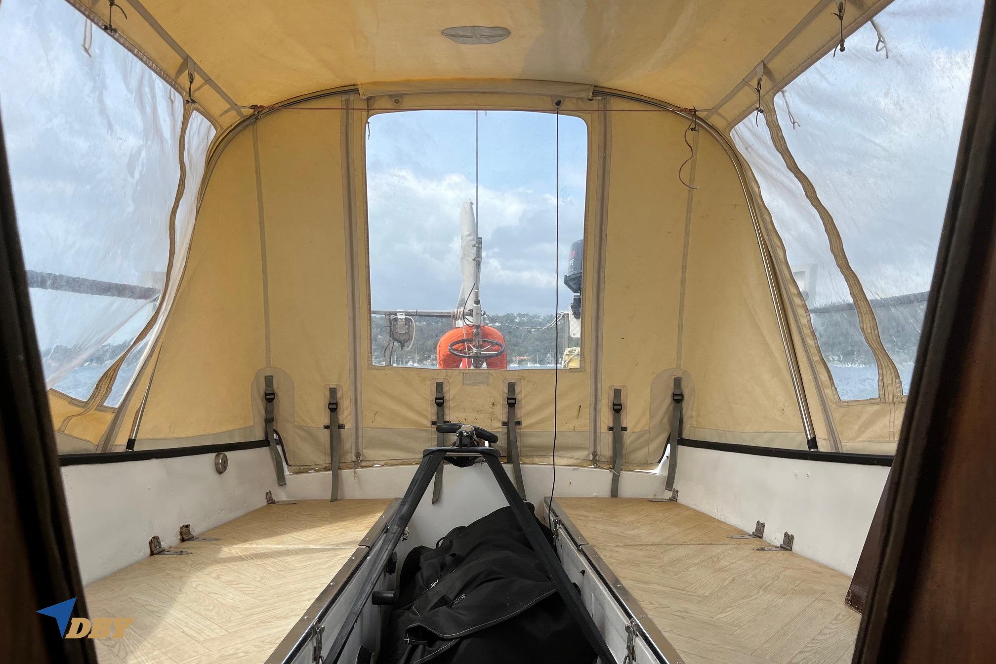 Interior view of 1982 Reinke Taranga 33 sailboat with beige canopy and clear windows.
