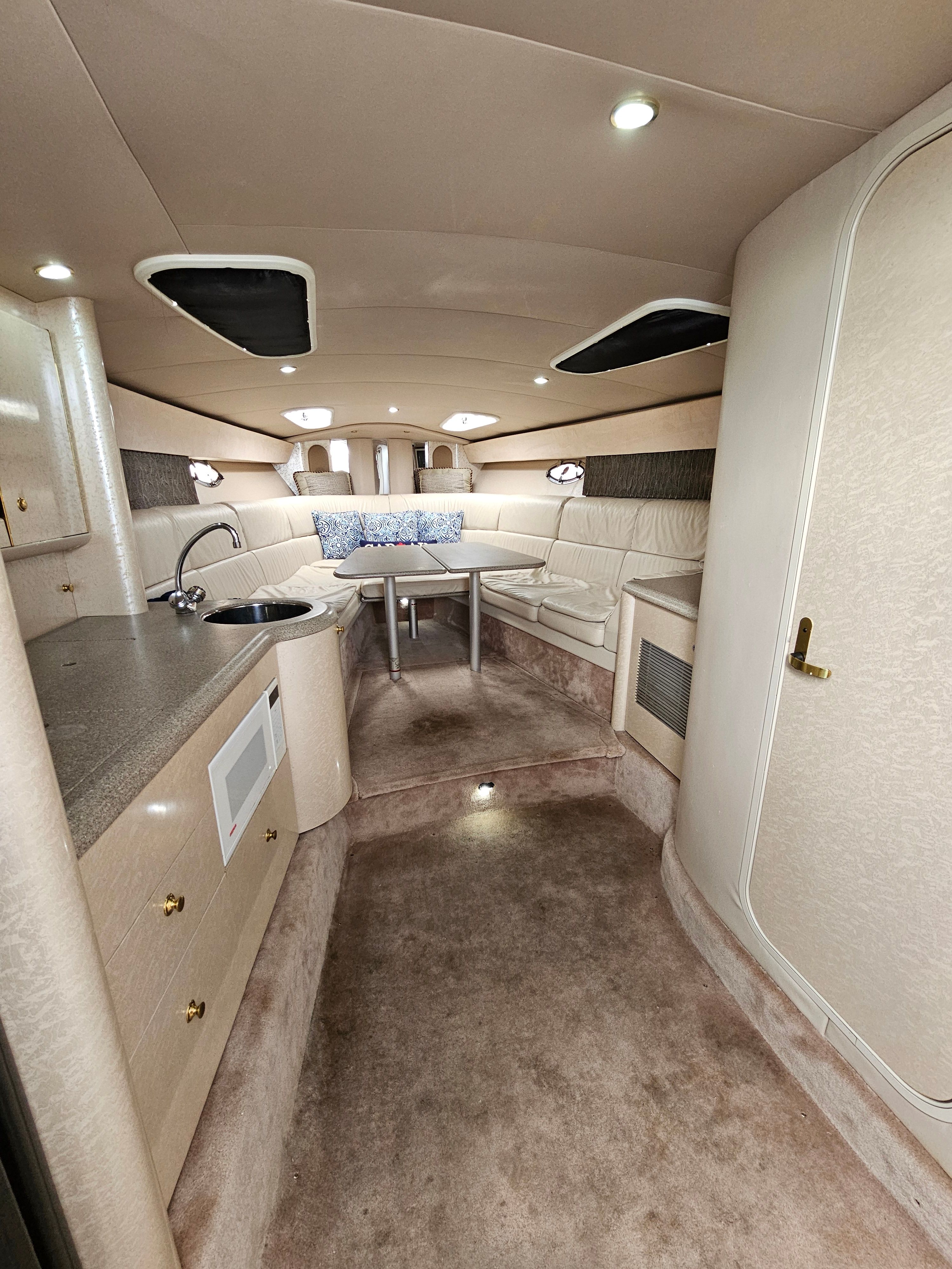 Interior of a 2001 Formula 400 Super Sport with kitchenette, seating area, and table.