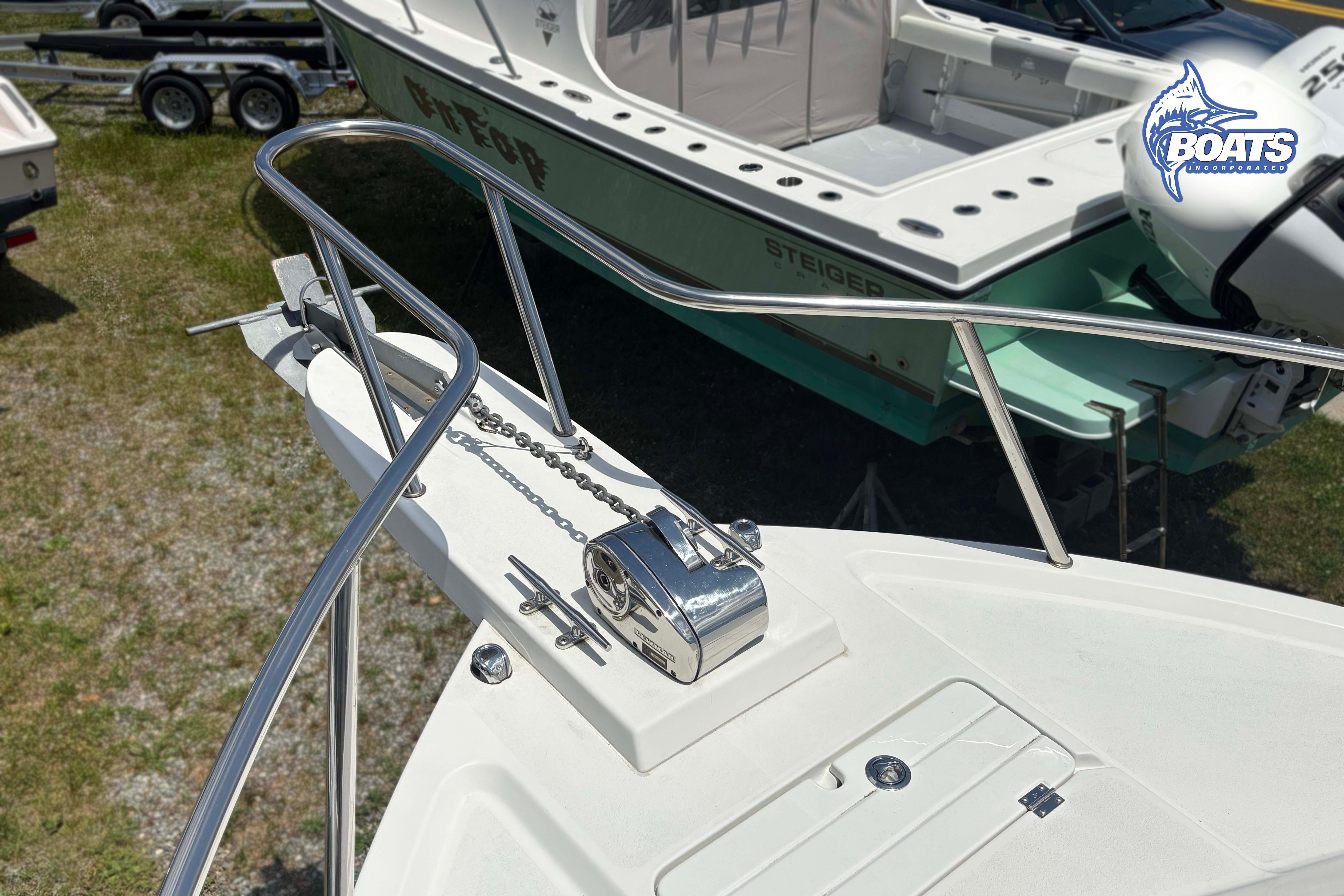 Bow of 2021 Parker 2520 XLD Sport Cabin with anchor chain and railing.