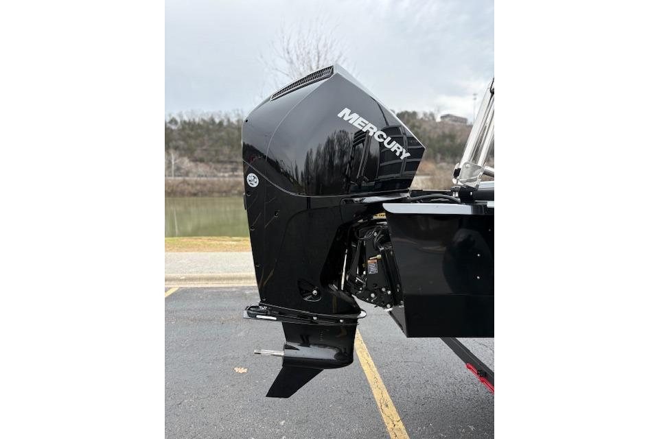 2025 Ranger Reata 243C with Mercury outboard motor, parked near a lake.