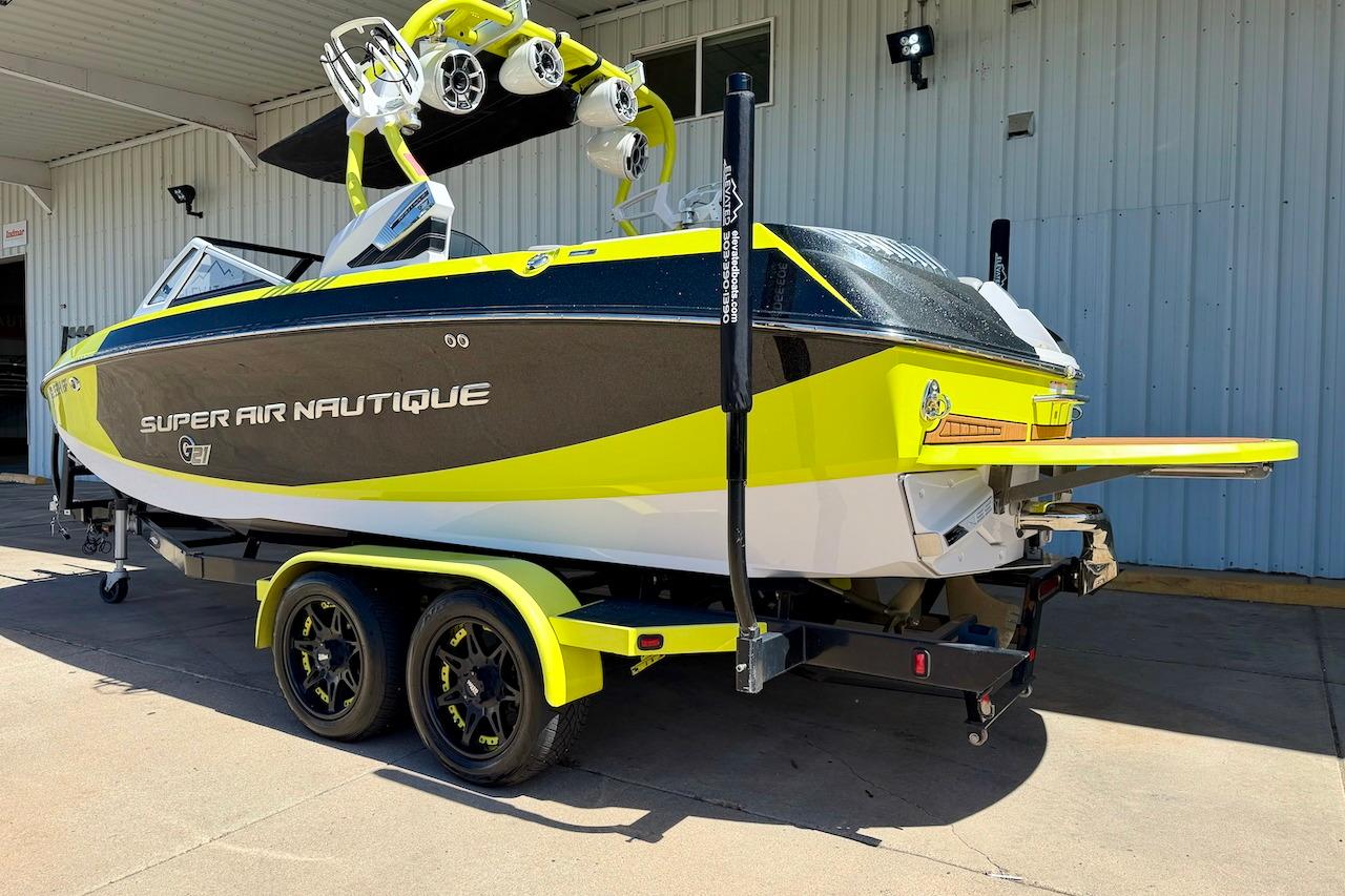 2014 Nautique Super Air Nautique G21 boat on trailer, vibrant yellow and black design.