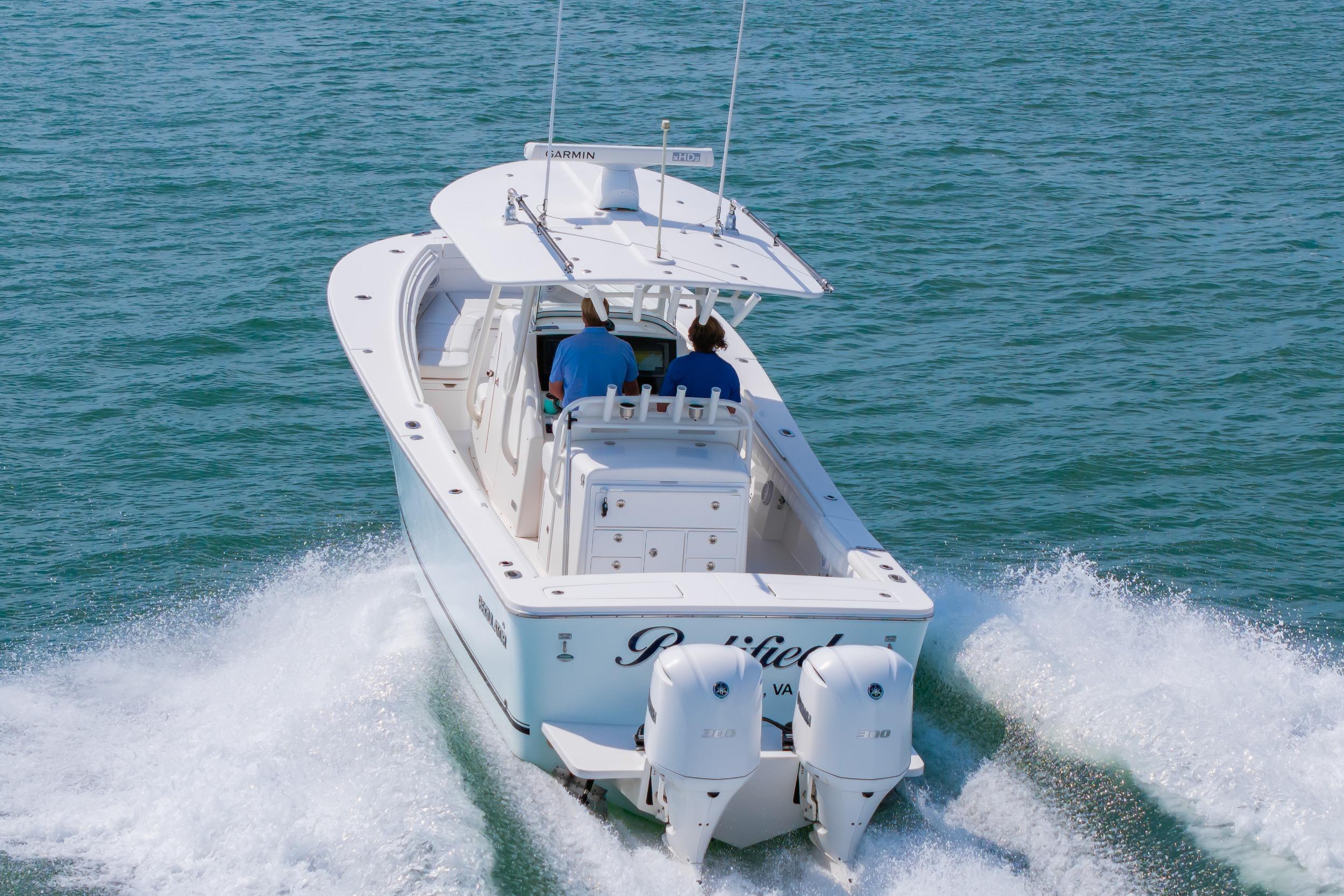 2019 Regulator 31 boat cruising on open water with twin engines.